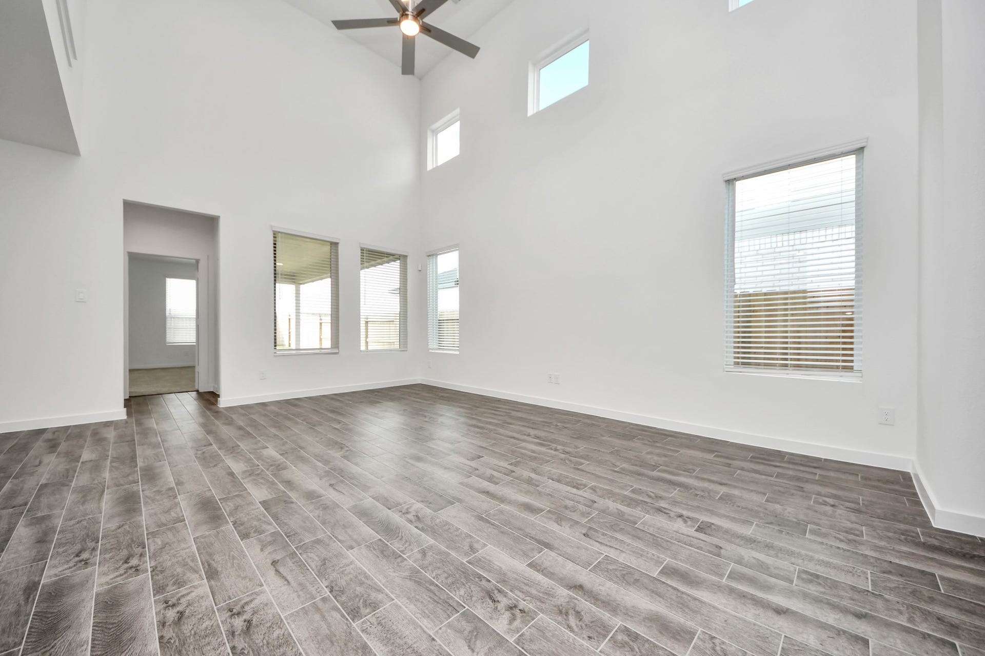 5822 Madison Trail Drive, Richmond, TX 77469 Gather the family and guests together in your lovely living room! Featuring soaring high ceilings, recessed lighting, ceiling fan, custom paint, gorgeous floors, and large windows that provide plenty of natural lighting throughout the day. Sample photo of completed home with similar floor plan. Actual colors and selections may vary.