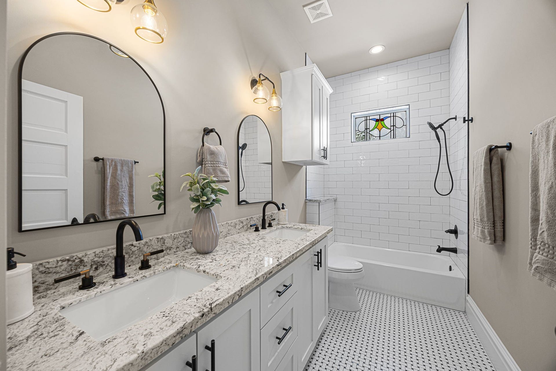 The upstairs 2nd bathroom offers a tub/shower combo, as well as a dual sink vanity with granite countertops.