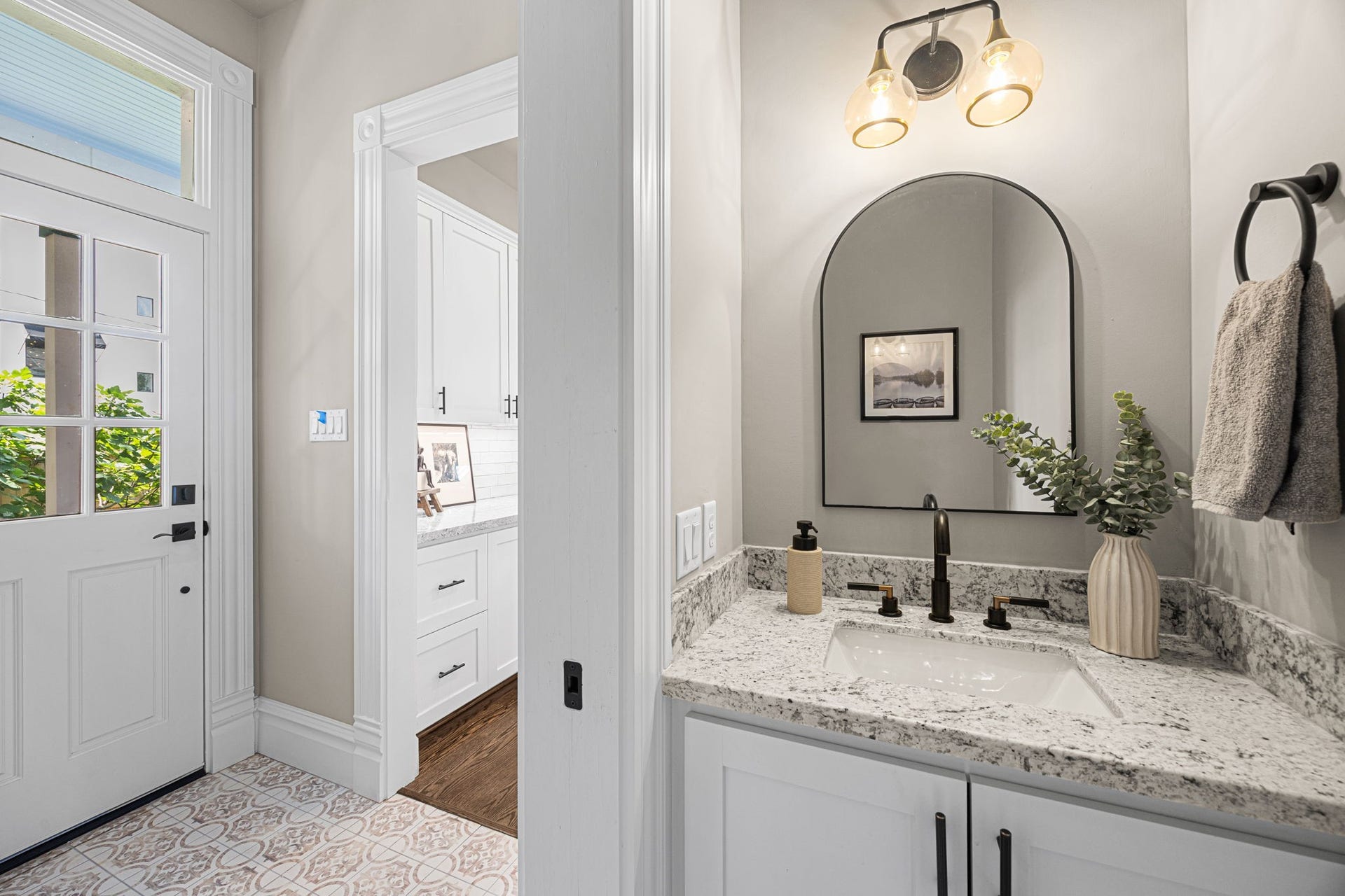 The downstairs powder bathroom offers a perfect escape away from others.  The location by the back door makes this space practical for both guests as well as the eventual pool guests (once it's been added).
