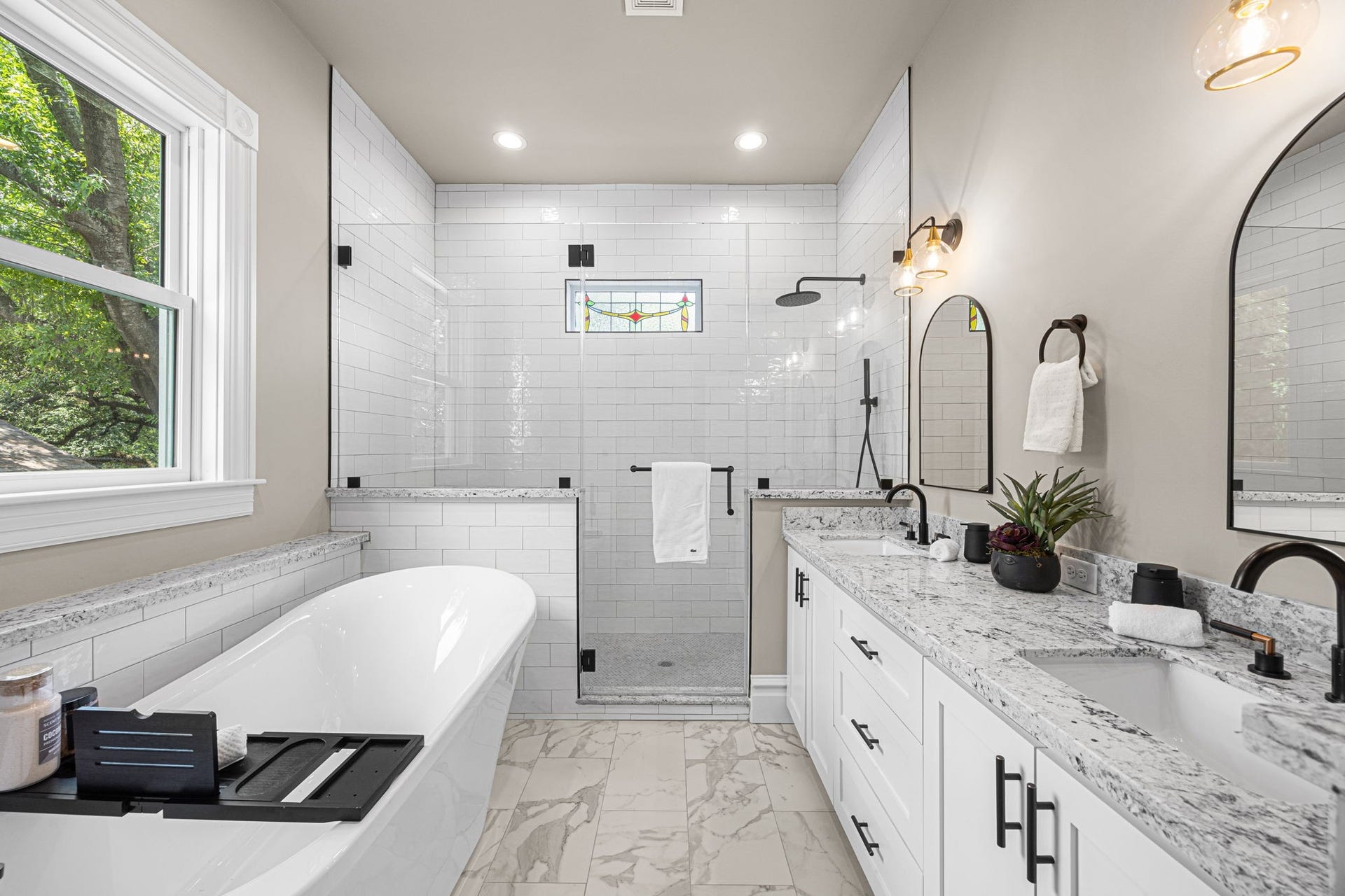 Welcome to the en-suite primary bathroom. Enjoy all of the natural light that illuminates this space throughout the day.