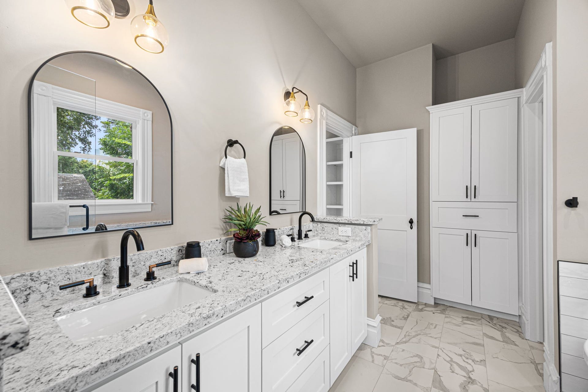 The primary bathroom offers granite countertops, a double vanity sink...and plenty of storage!