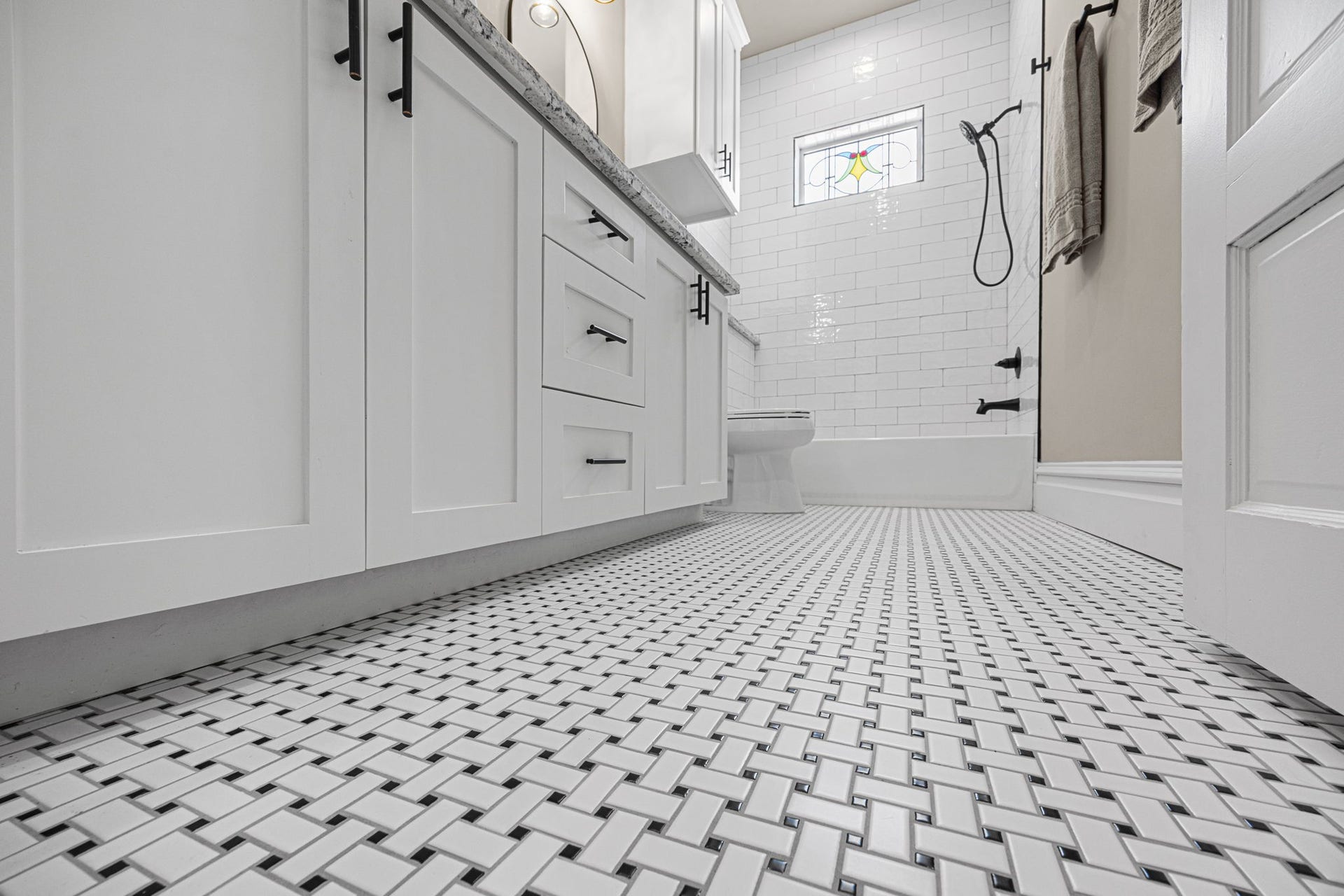 The bathroom flooring adds a dose of vintage charm in this space.