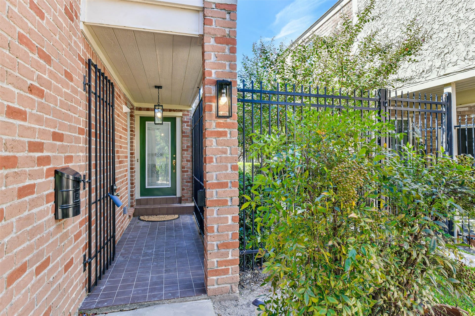 The gated entrance is on the side of the home.