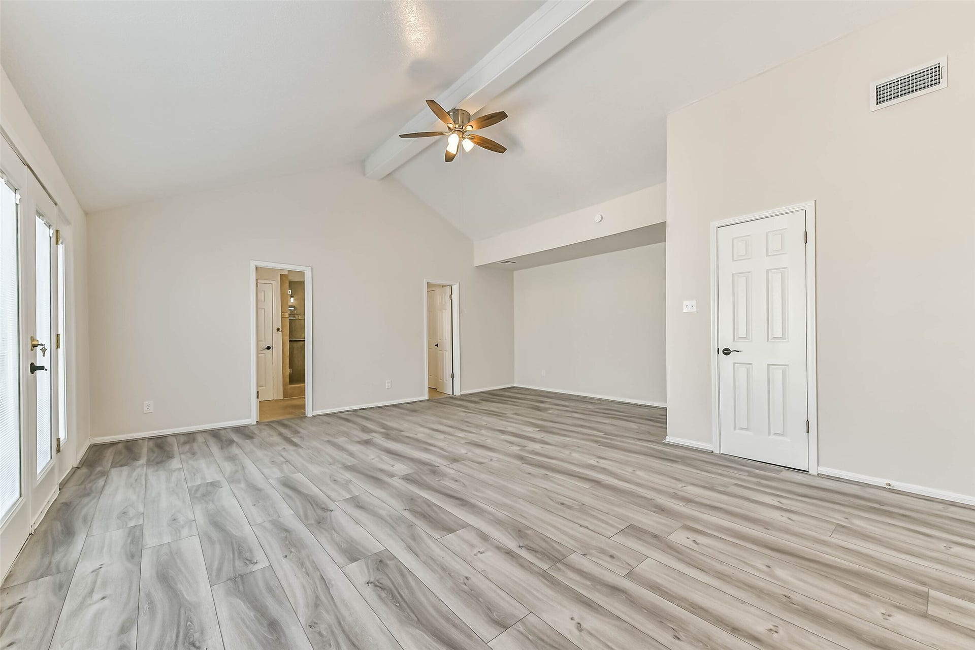 Upstairs, the primary bedroom is very spacious with luxury vinyl plank floors, high ceilings, a ceiling fan, three closets and access to the private balcony!