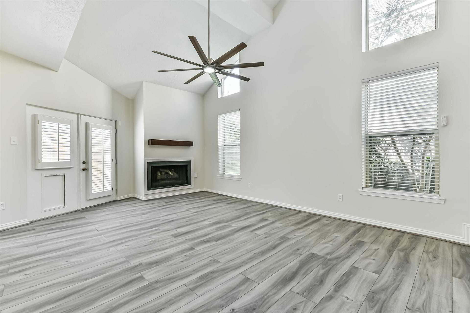 The family room has a gas fireplace and high ceilings with an over sized ceiling fan.