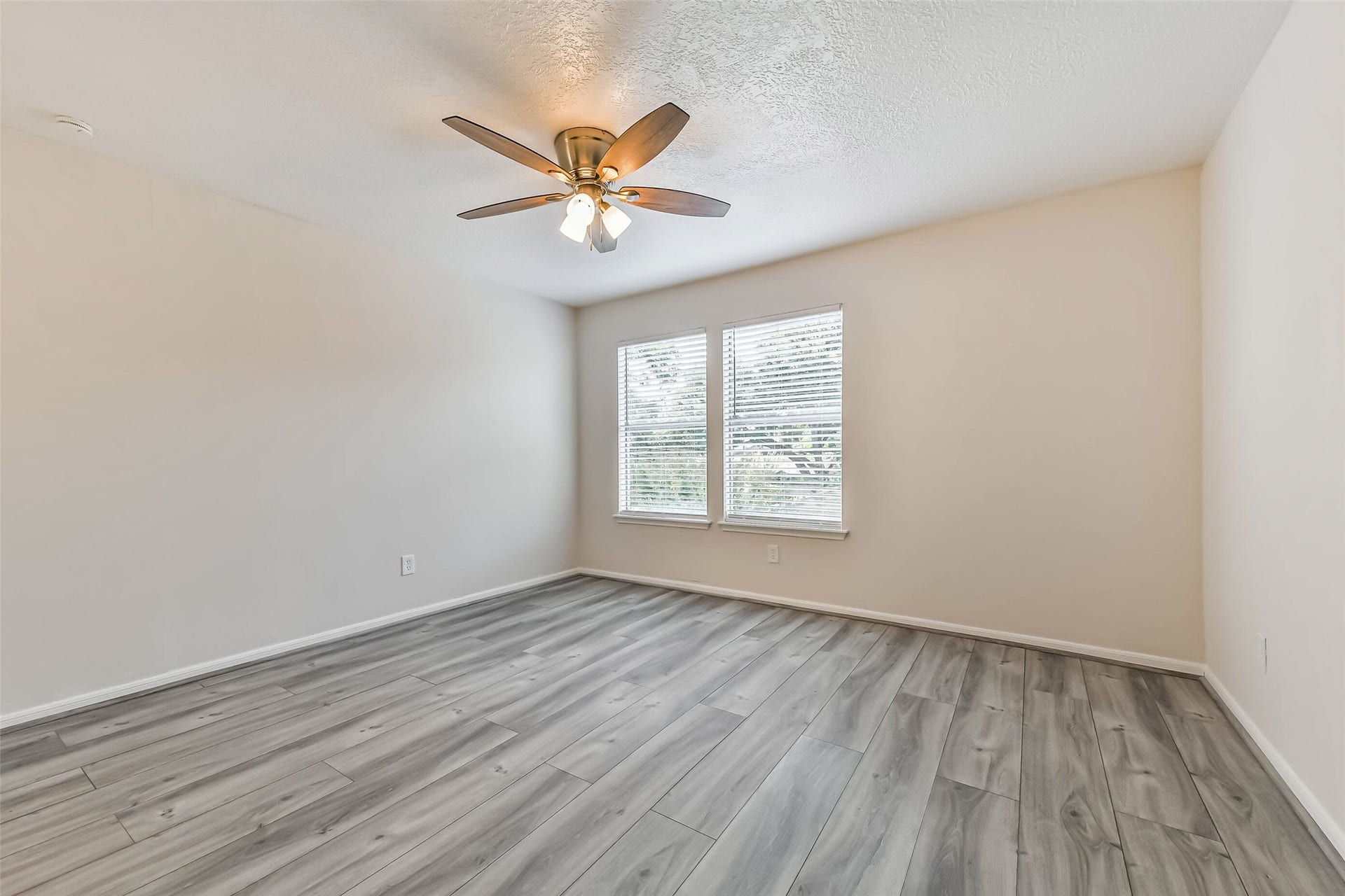 The second bedroom is also located on the second floor with luxury vinyl plank floors, a ceiling fan and nice size walk in closet.