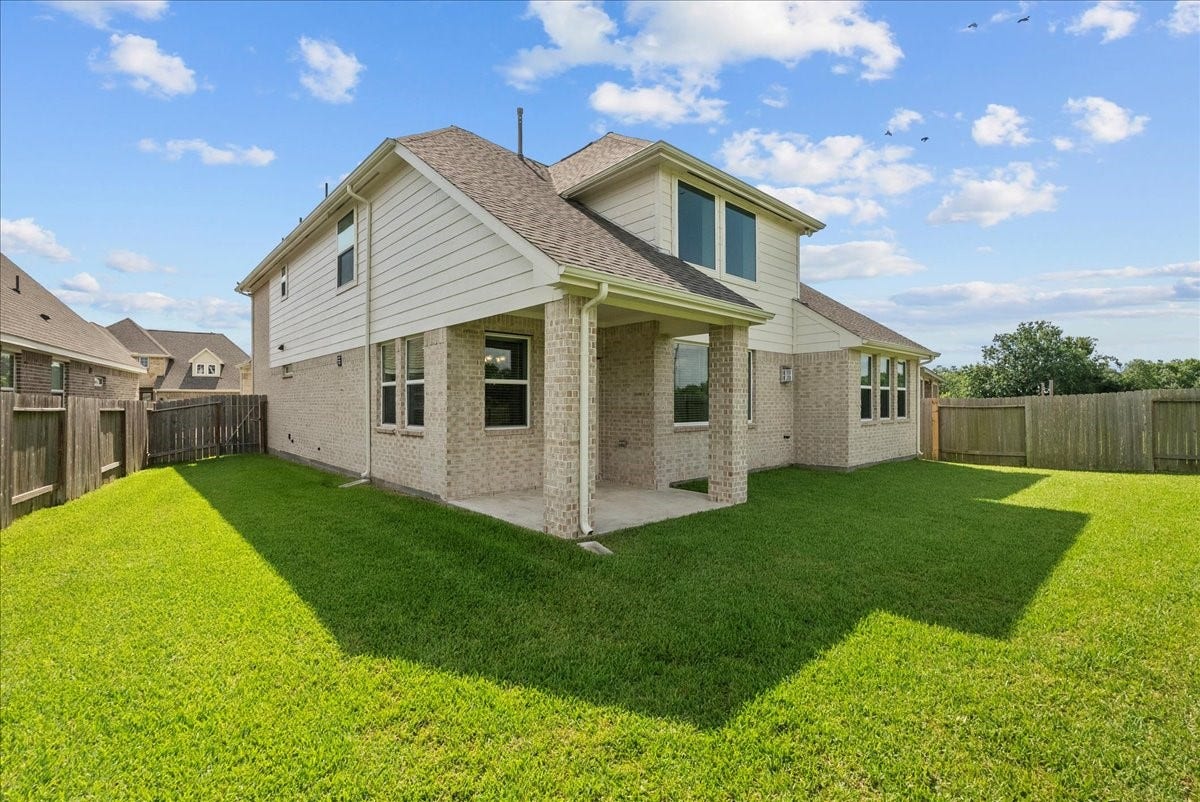 Nice size backyard with a covered patio and water views