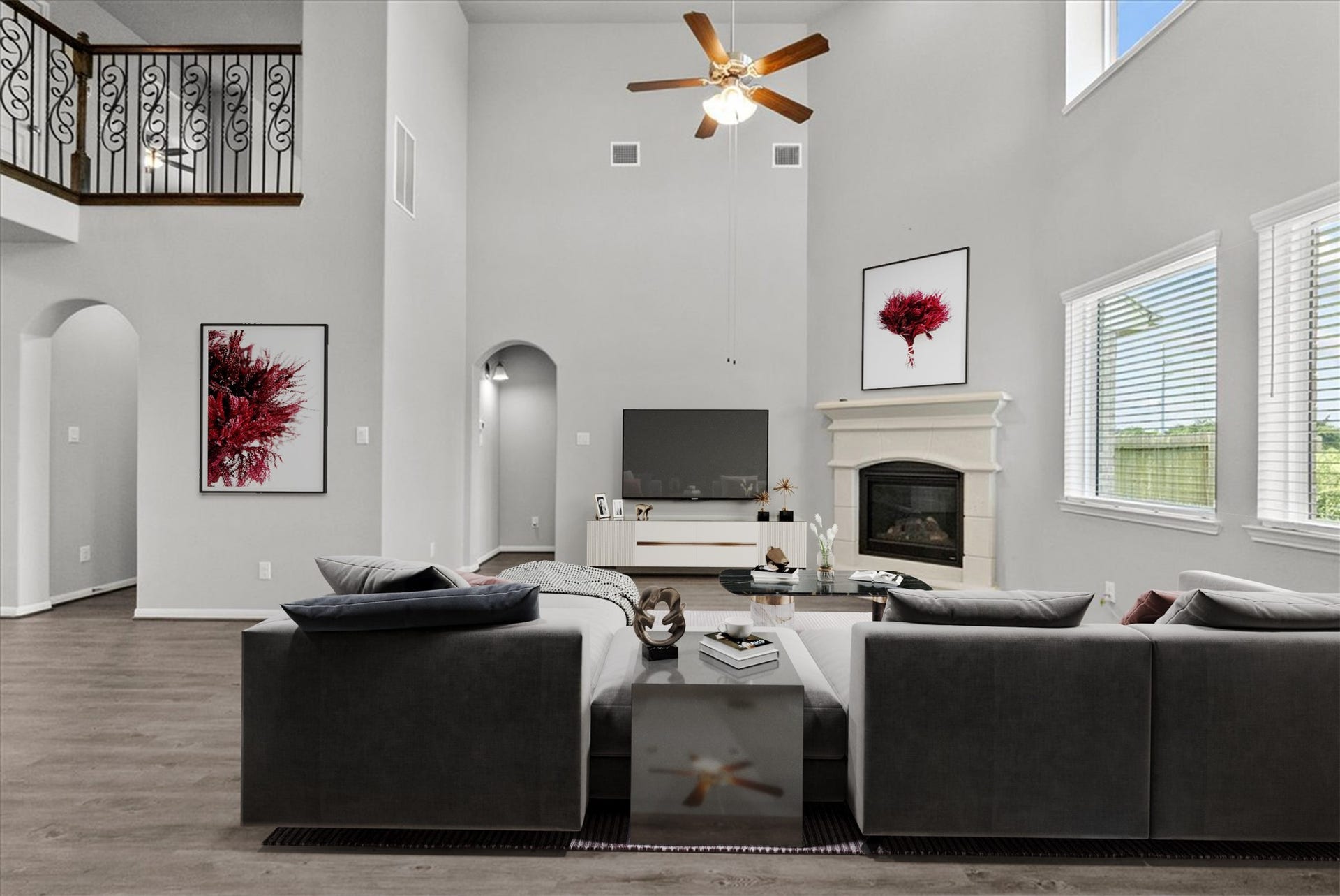 Living room features two-story ceilings and a cozy fireplace for those cold winter nights