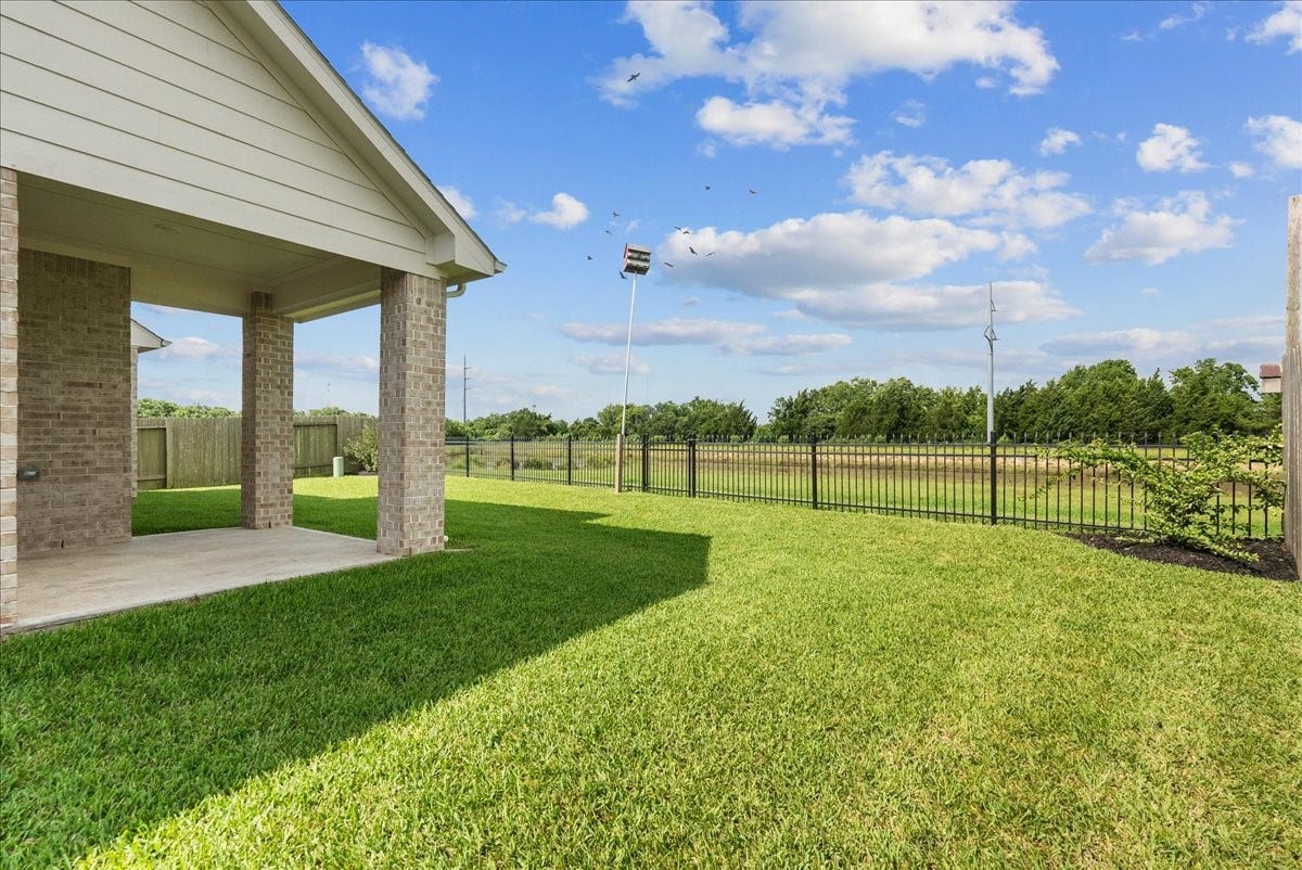 Nice size backyard with a covered patio and water views