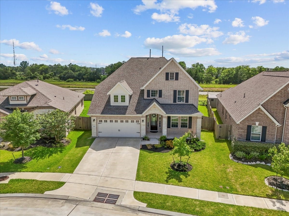 Stunning two-story home with brick and stone elevation with no back neighbors and water views