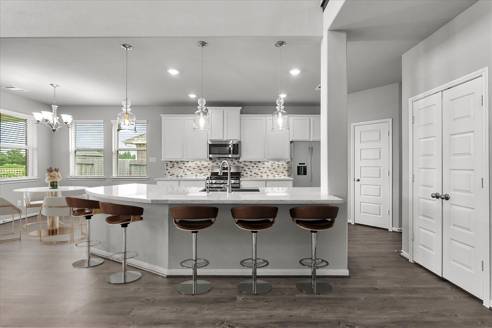 Chef's eat-in island kitchen features 42" cabinets with crown molding, stainless steel appliances and and designer backsplash