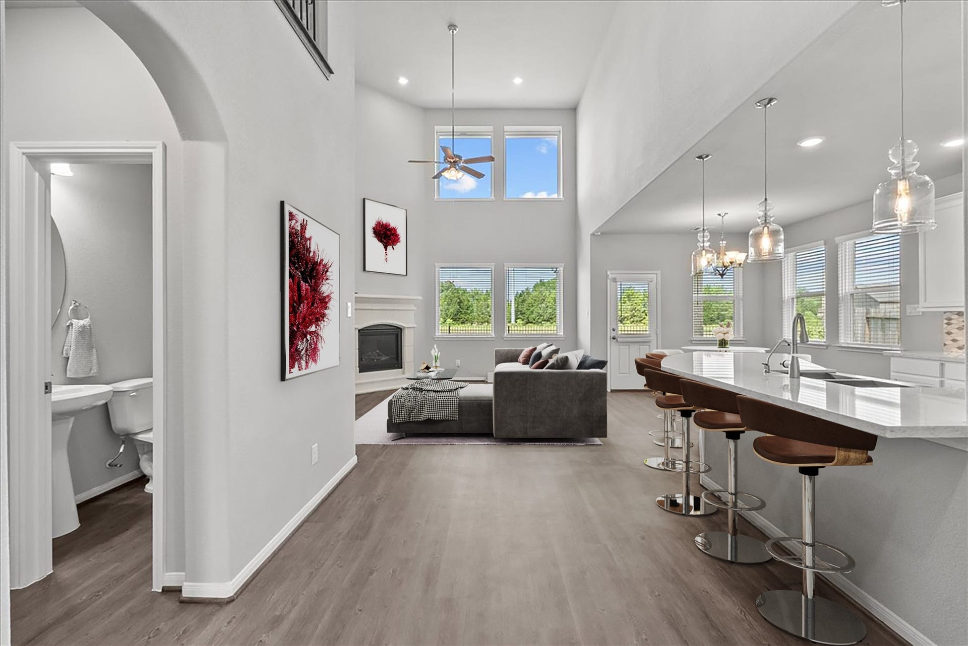 The living room open to the kitchen features two-story ceilings