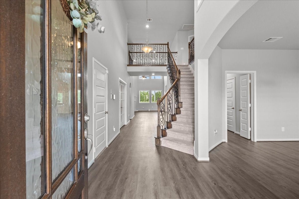 Enter from a covered front porch to soaring ceilings
