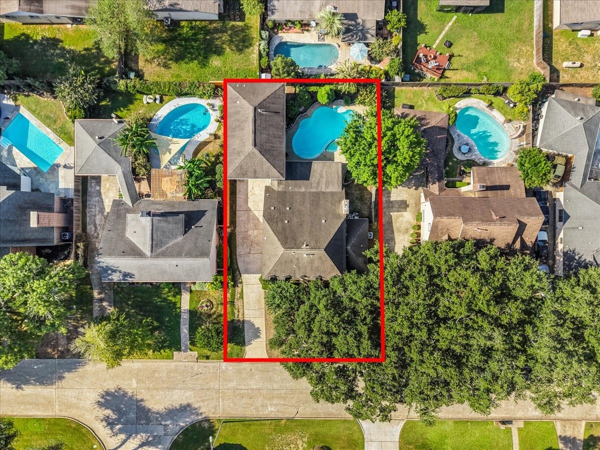 Spacious property featuring a large backyard with a private pool, surrounded by lush greenery for added privacy and relaxation.