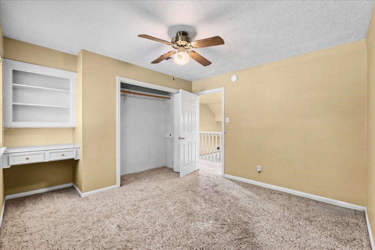Upstairs, the second bedroom offers functionality with a built-in desk, perfect for work or study.