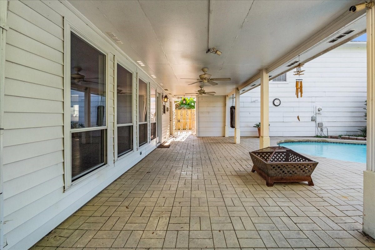 Experience outdoor living at its finest with a spacious covered patio perfect for relaxation and entertaining, seamlessly extending to the inviting pool area.