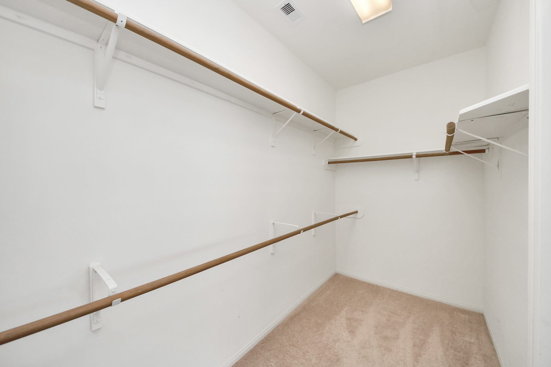 5815 Pheasant Ridge Lane, Houston, TX 77041 Spacious walk-in closet featuring ample hanging space and shelving, perfect for organizing your wardrobe essentials.