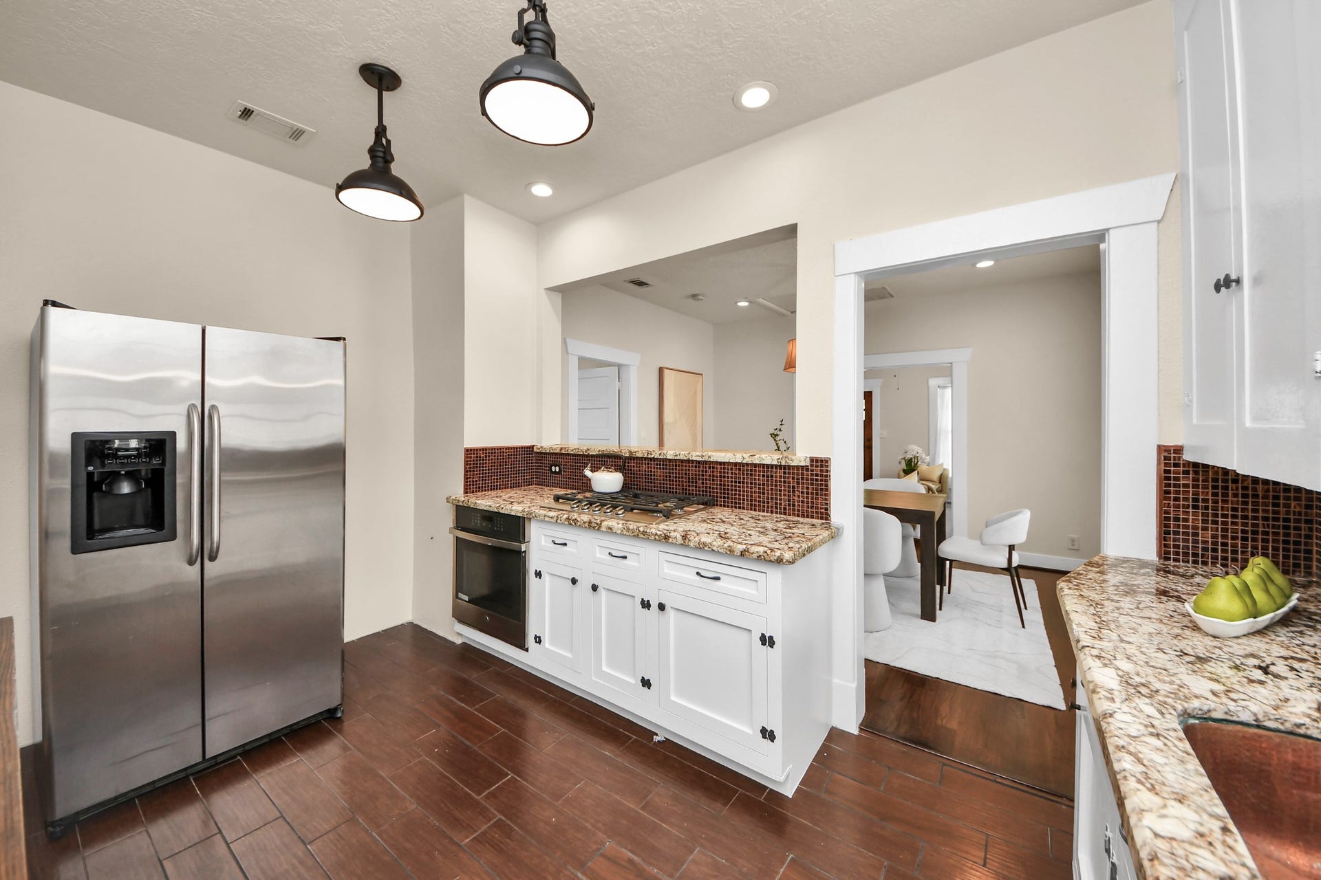 The kitchen flows seamlessly into the dining area, creating an inviting space for everyday living and effortless entertaining.