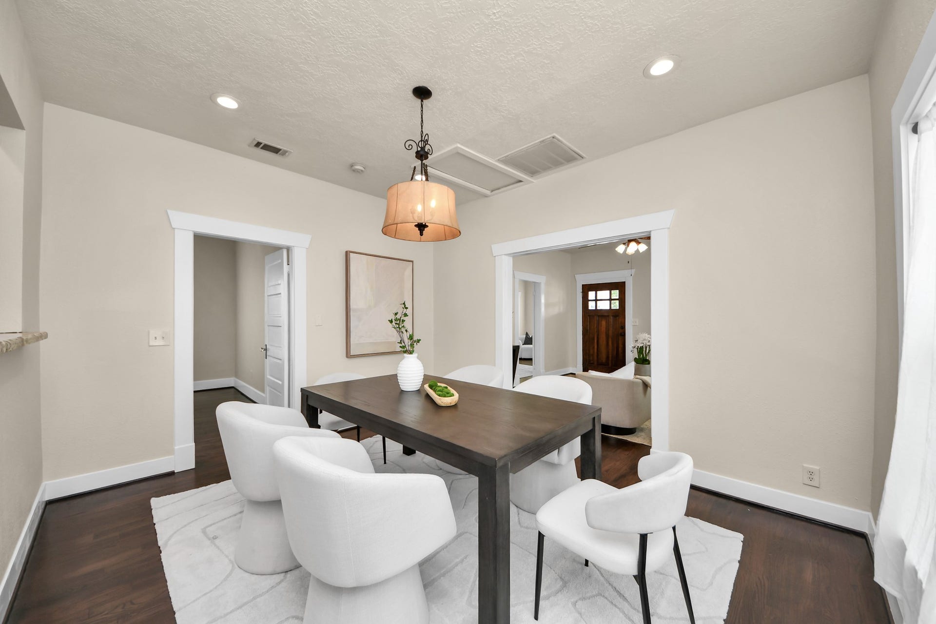 Bright and inviting dining area featuring recessed lighting and a warm pendant lamp, creating a cozy atmosphere.