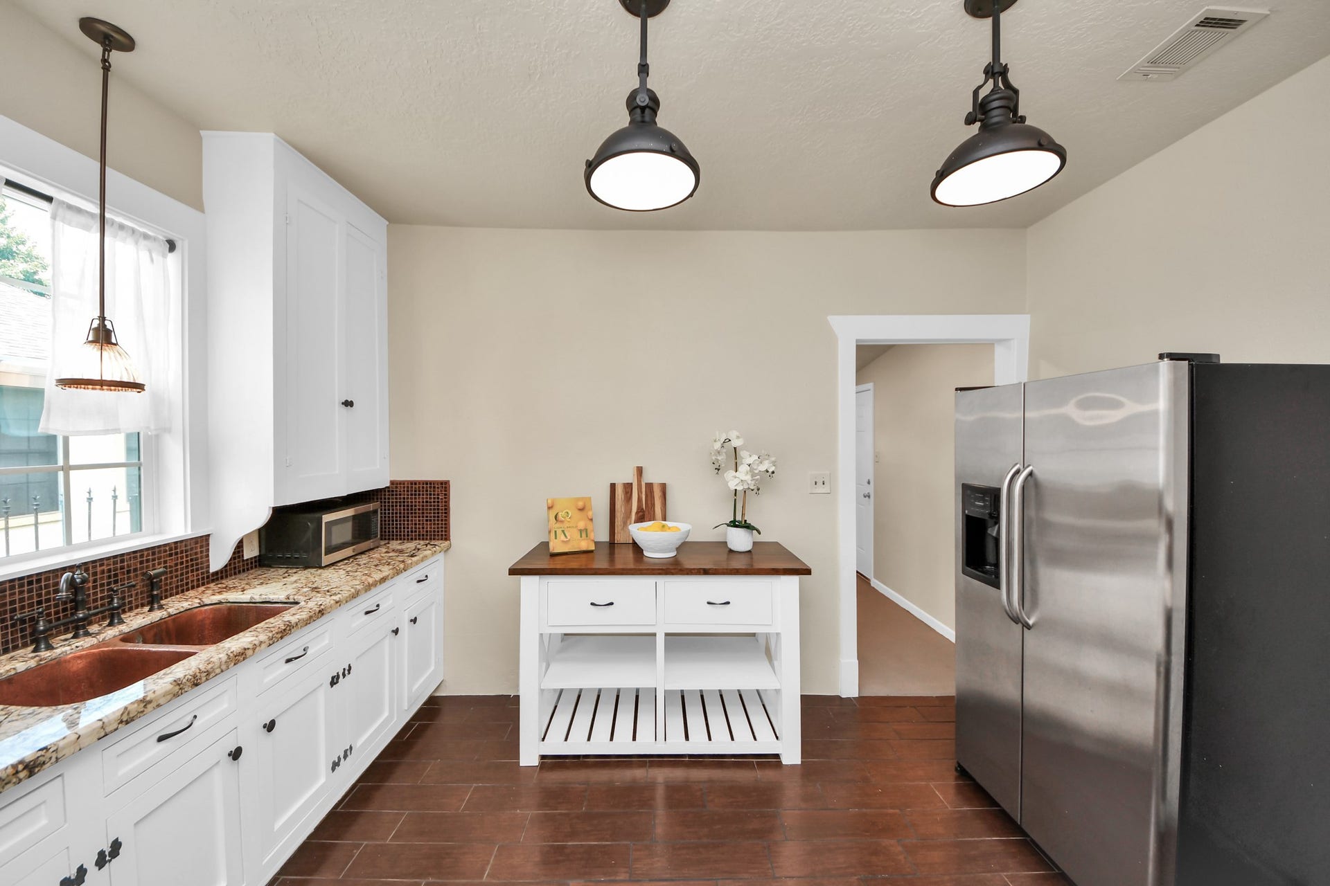 Kitchen features a double sink and connects seamlessly to adjacent rooms.