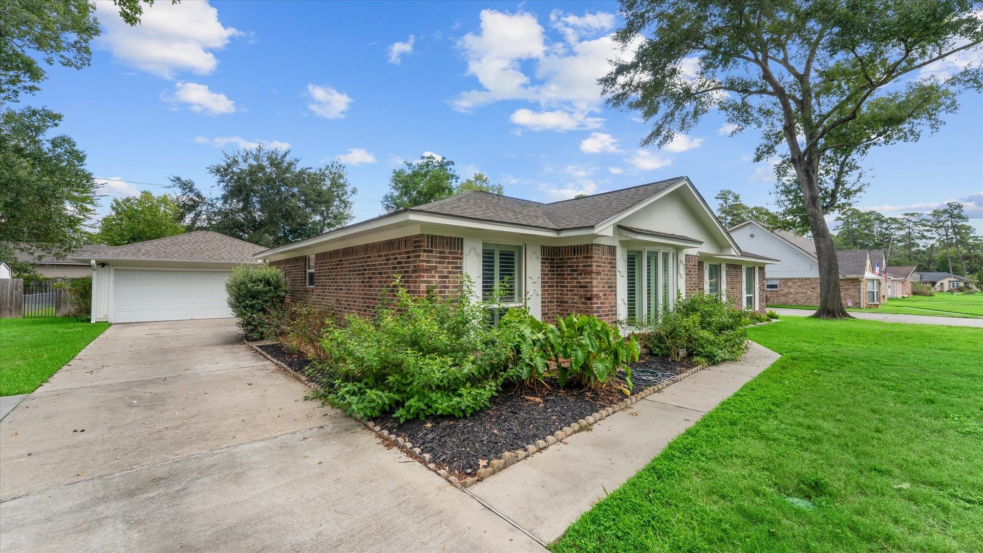 207 Woodway Court, Spring, TX 77386 Charming brick home at 207 Woodway Ct, Spring, TX, nestled on a lush lot with mature trees, featuring a spacious driveway leading to a detached garageperfect for serene suburban living.