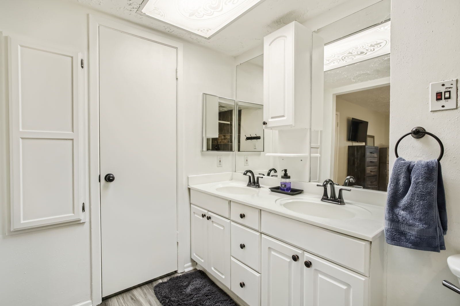 Primary bathroom features dual sinks, custom walk-in closet and built-in iroining board.