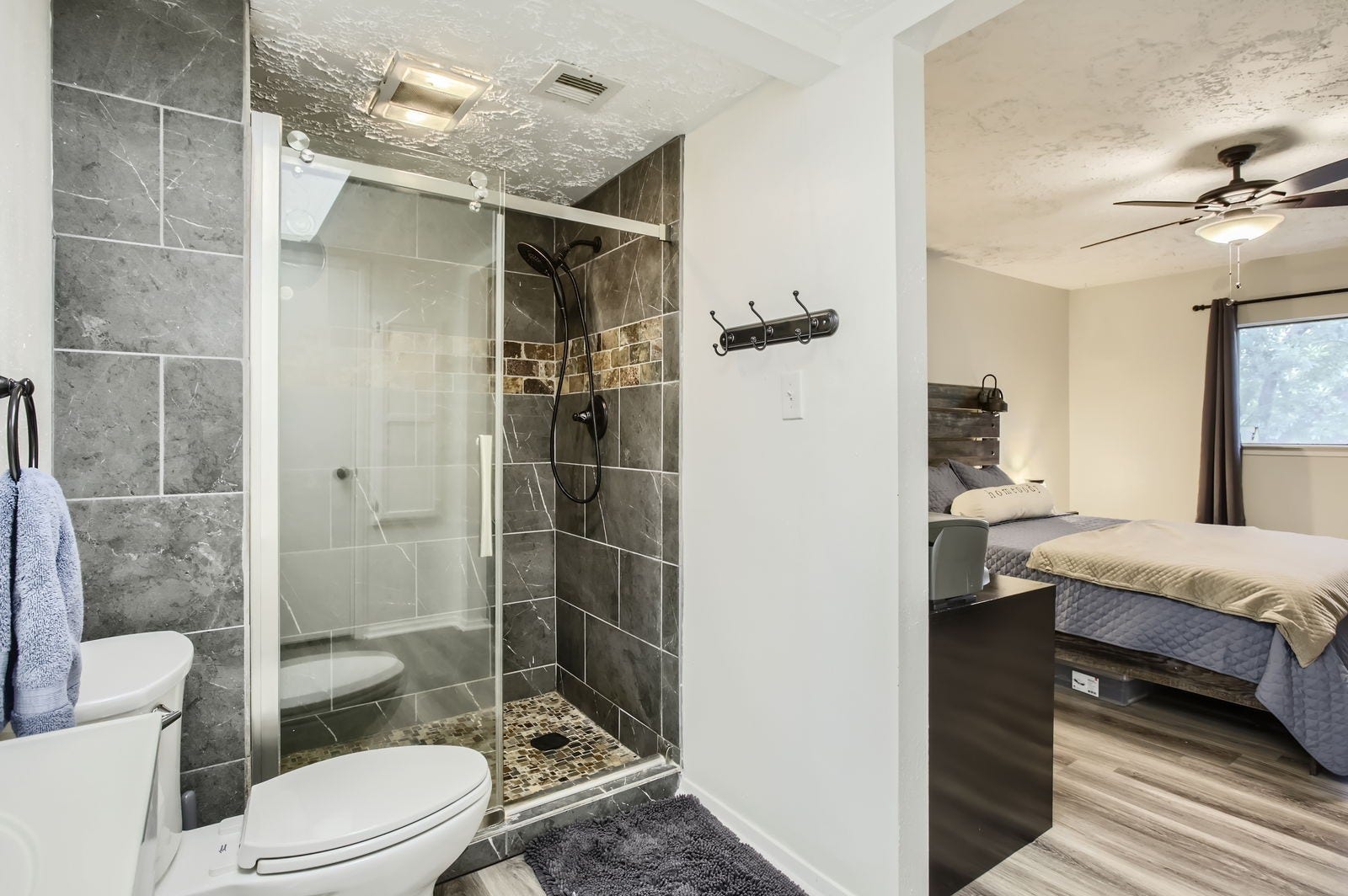 Primary bathroom features a large slate tile shower.