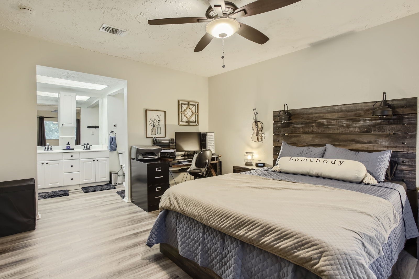 The roomy primary bedroom features recently installed luxury vinyl flooring, as well as an ensuite bathroom.