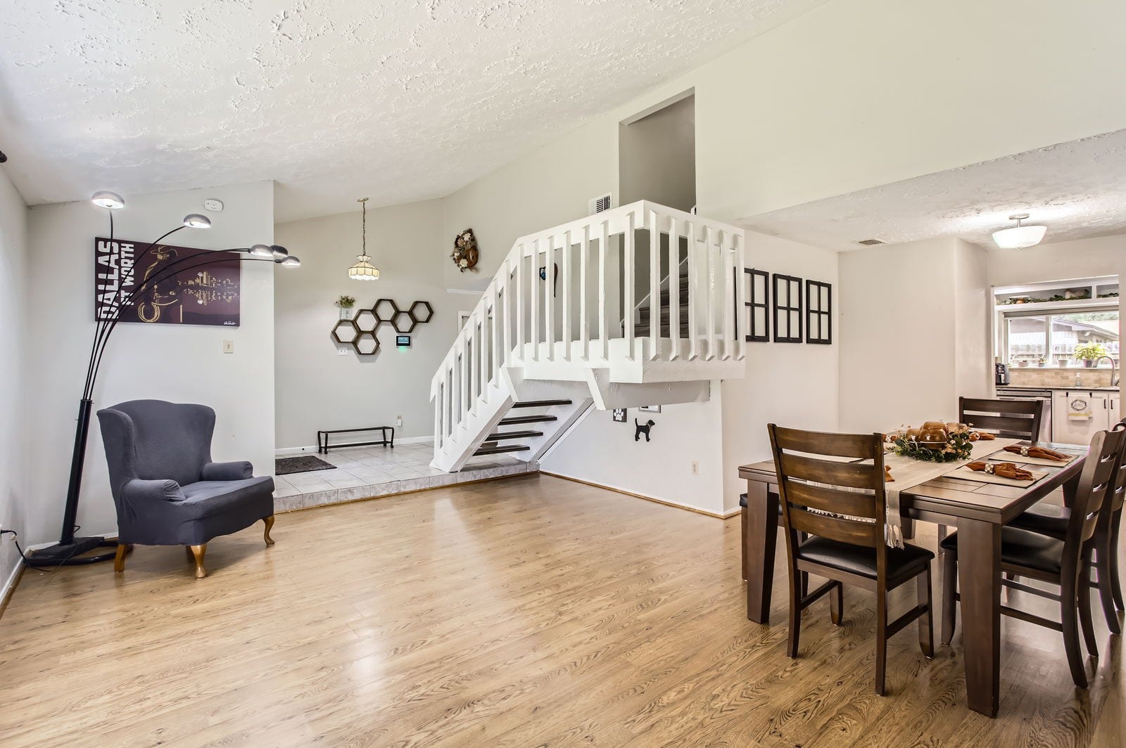 The wrap-around style of the formal living & dining rooms makes this space highly versatile, and features beautiful wood laminate flooring.