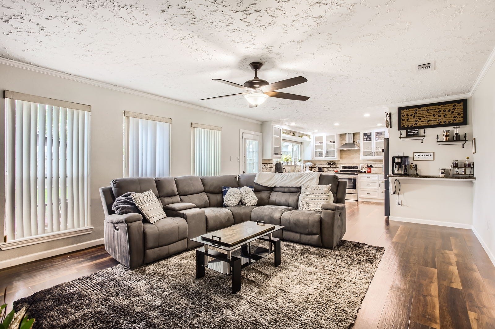 The spacious family room feature rich hickory flooring, double-pane windows, and a versatile dry/coffee bar.