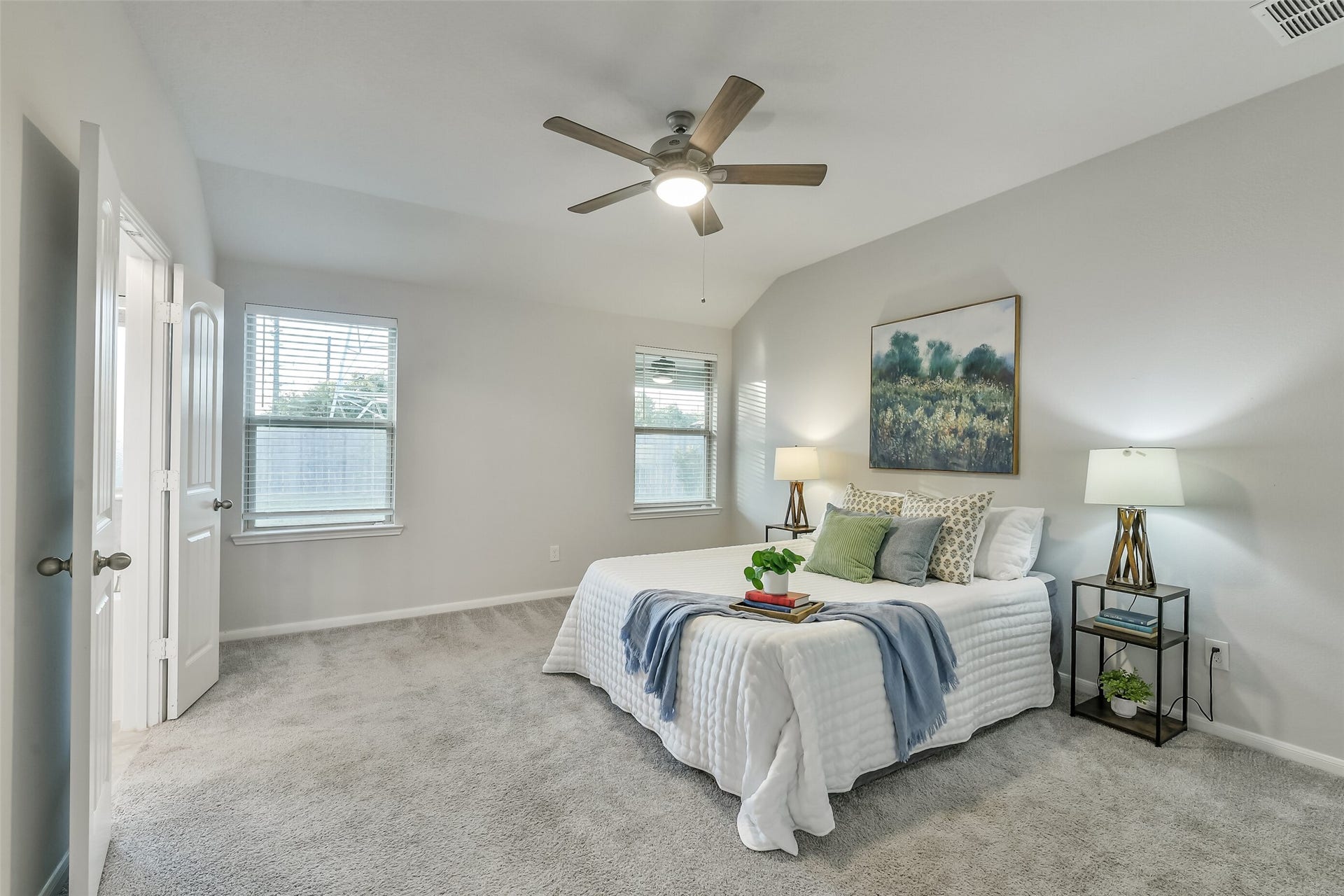 19450 Tobiano Park Drive, Tomball, TX 77377 The primary bedroom features a ceiling fan and plenty of natural light with full blinds for privacy.