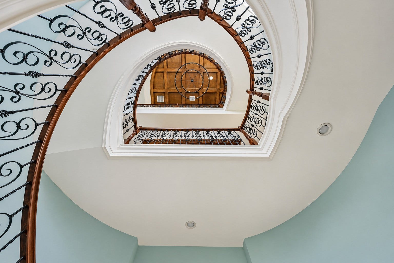 12 Fleming, Hitchcock, TX 77563 Step through the front door and look up. A soaring three-story foyer opens above you, flooded with natural light and anchored by one of the most dramatic architectural features in all of Harborwalk an elegantly curved staircase that rises through every level of the home. This is the moment buyers remember.