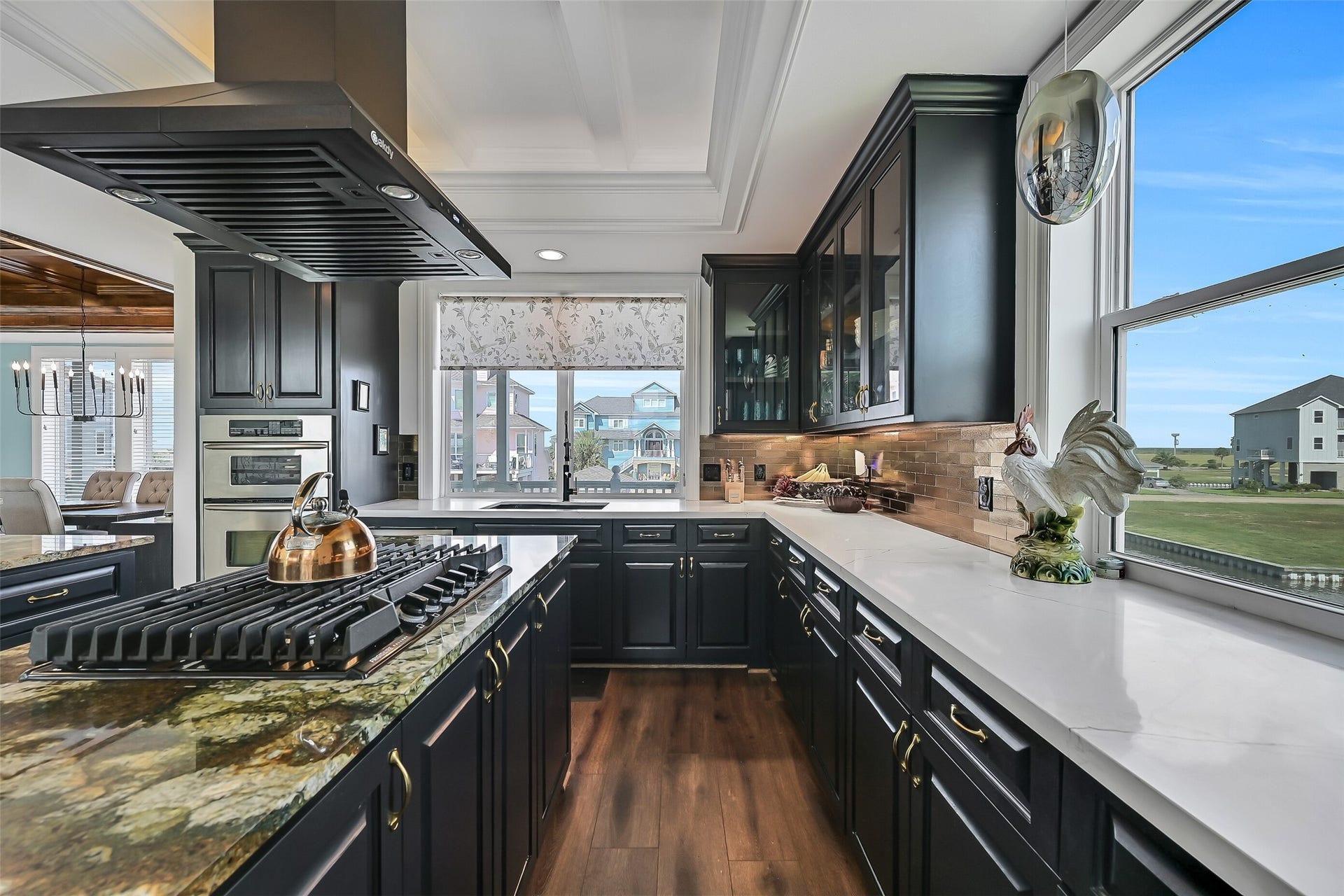 12 Fleming, Hitchcock, TX 77563 Hand-built coffered judges ceiling, glass-door upper cabinets, and Della Terra quartz perimeter counters. This is the kitchen other Harborwalk homes don't have.