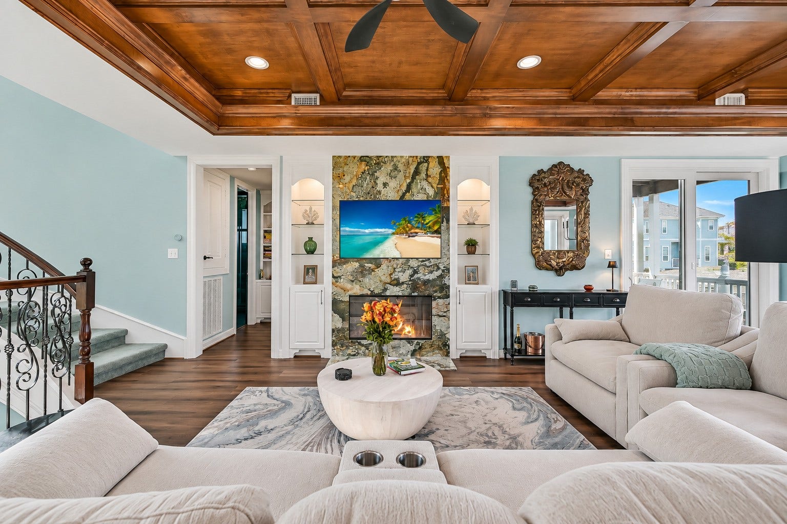 12 Fleming, Hitchcock, TX 77563 A Brazilian granite gas fireplace anchors one end of the room while floor-to-ceiling windows flood the space with natural light and frame the water beyond. Beautiful luxury waterproof wide-plank flooring, designer paint, and custom built-in cabinetry make this a living room that feels as intentional as it is beautiful.