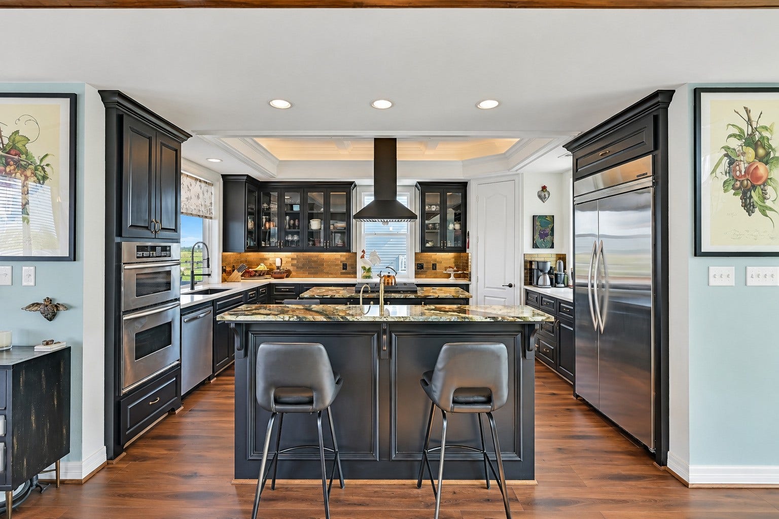 12 Fleming, Hitchcock, TX 77563 Commercial KitchenAid refrigerator. GE Monogram beverage fridge. KitchenAid wall oven and microwave. Custom freestanding hood over the center island. Every detail intentional.