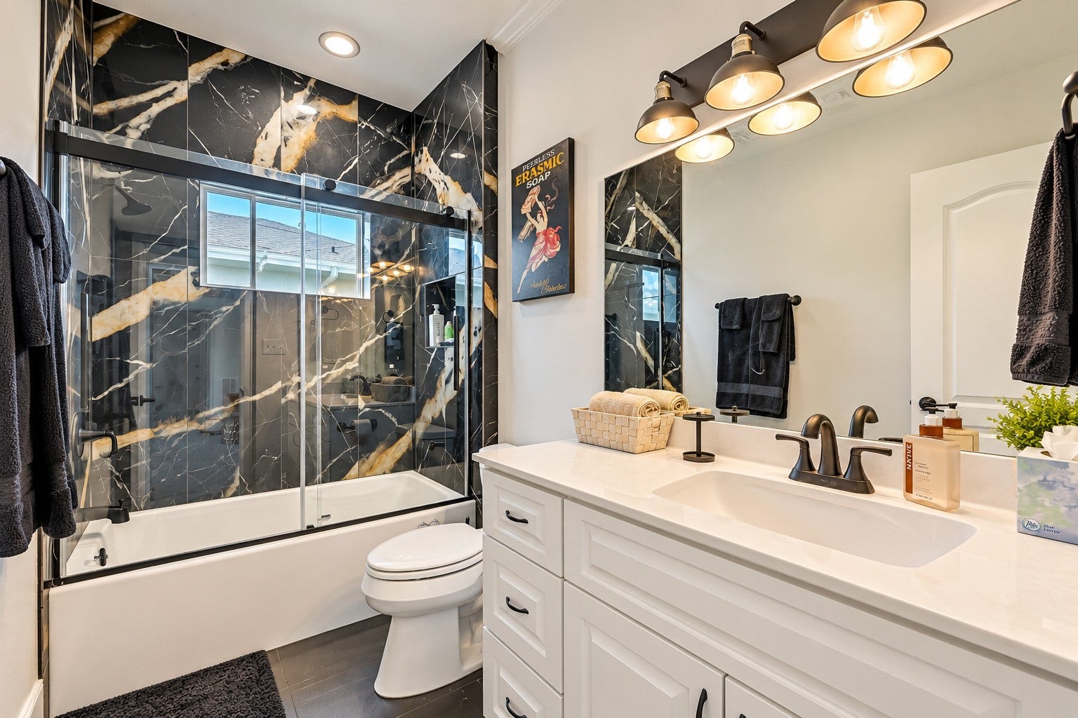 12 Fleming, Hitchcock, TX 77563 No detail was overlooked in the second guest bath. Custom tile, new Pfister plumbing fixtures throughout, and a fresh modern finish that ties seamlessly into the overall luxury aesthetic of the home. Function and beauty in equal measure.