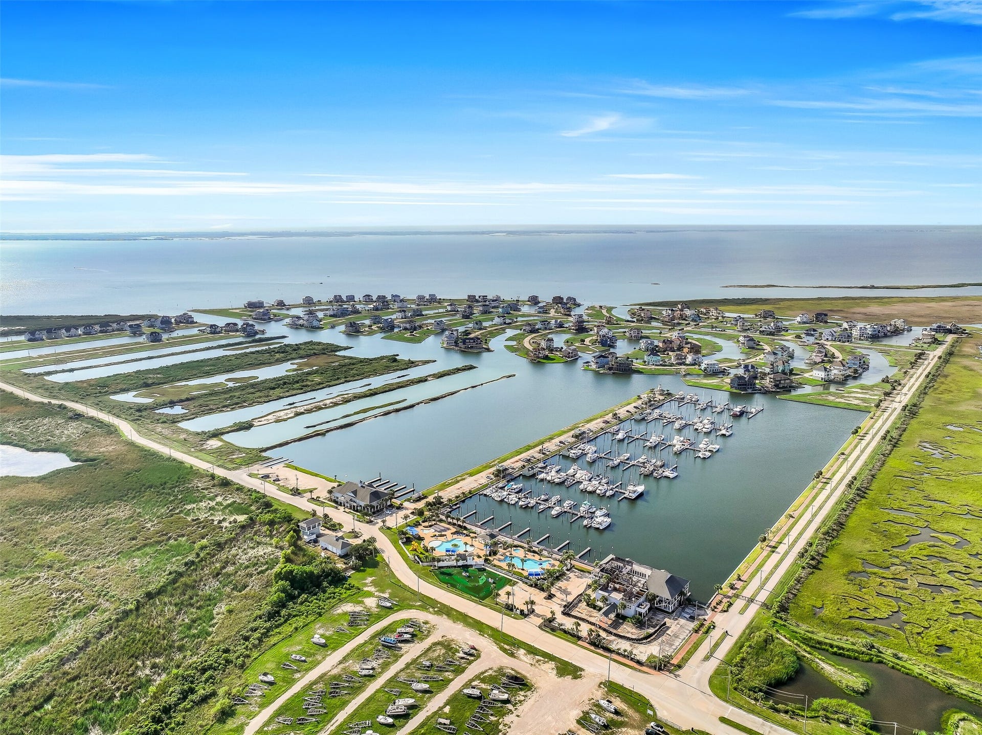 12 Fleming, Hitchcock, TX 77563 There is no better way to end the day than watching the Gulf Coast sky turn gold from above the water. The aerial view of 12 Fleming at golden hour captures everything this property offers the canals, the community, the open sky, and a home that was built to be lived in fully. Come see it in person. The view from inside is even better.
