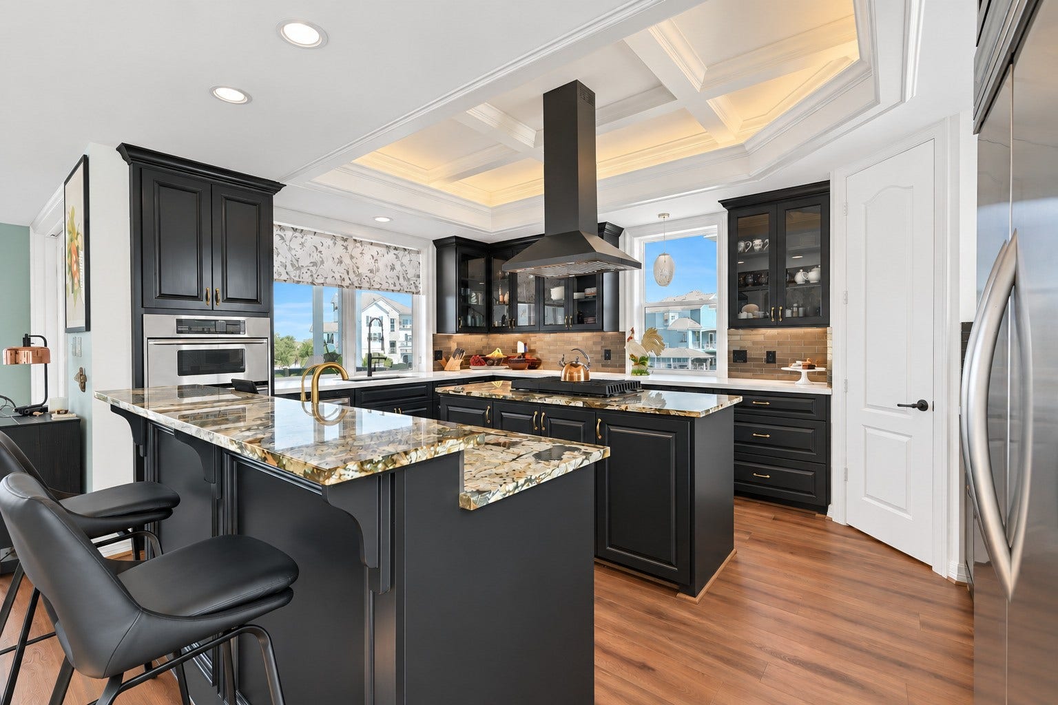 12 Fleming, Hitchcock, TX 77563 Dual Brazilian granite islands, custom under-lit cabinetry, and a commercial KitchenAid refrigerator this kitchen was built to entertain. Every detail is custom, everything is updated.