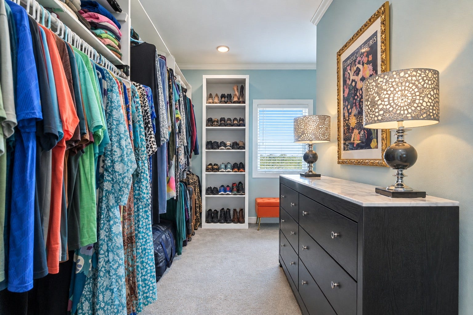 12 Fleming, Hitchcock, TX 77563 This is not a closet it is a dressing room. The primary suite walk-in closet features custom built-in shelving, dedicated drawer space, and enough room to organize everything with ease. Built as part of the full 2025 luxury rebuild, every inch was designed to be as functional as it is beautiful. The details in here are the kind you notice every single morning.