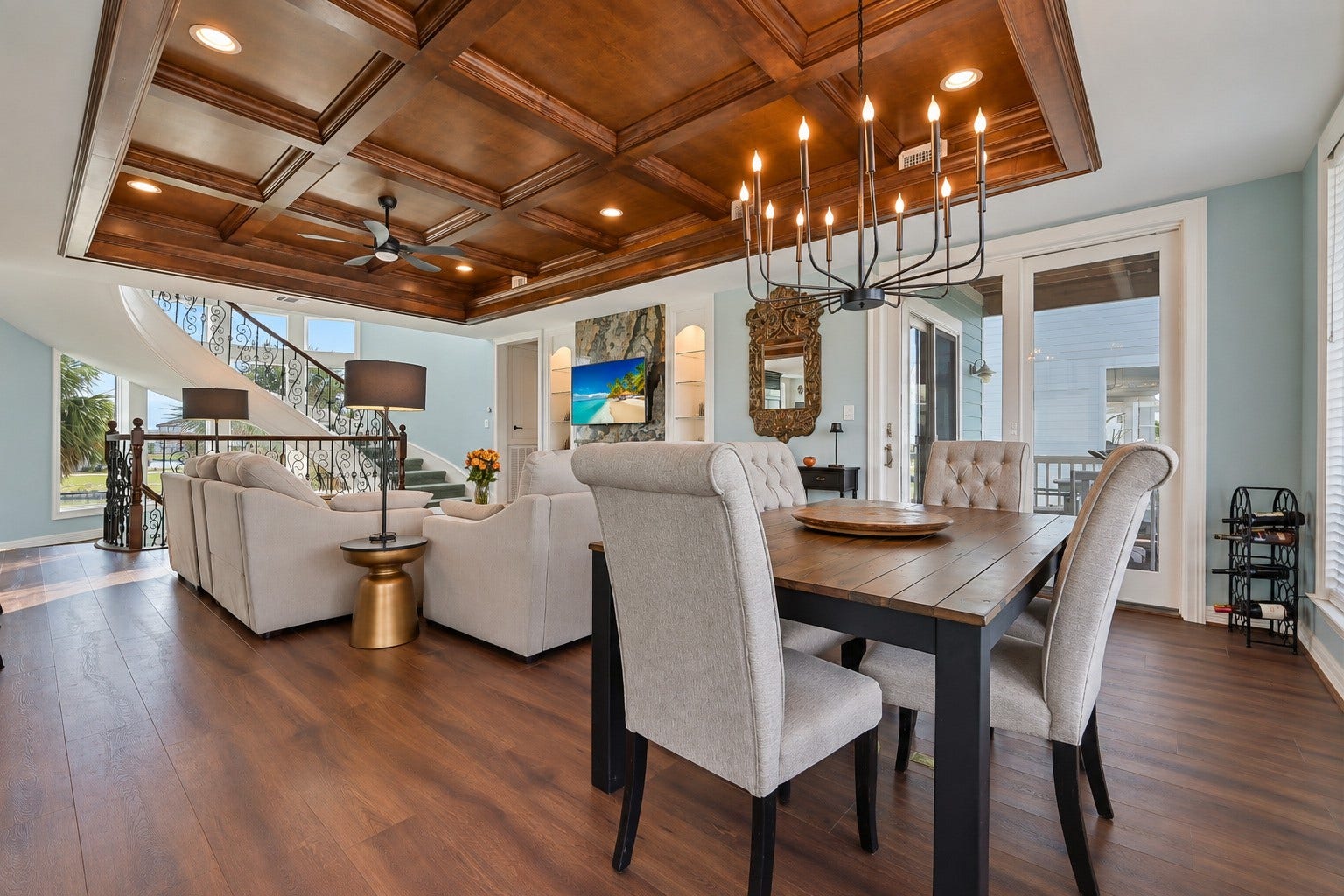 12 Fleming, Hitchcock, TX 77563 This dining room was designed for the way people actually gather. Wide open to the kitchen on one side and the balcony on the other, it moves effortlessly from casual weeknight dinners to full weekend entertaining. Updated luxury wide-plank flooring, designer paint, and custom woodwork throughout make the space as beautiful as it is functional.
