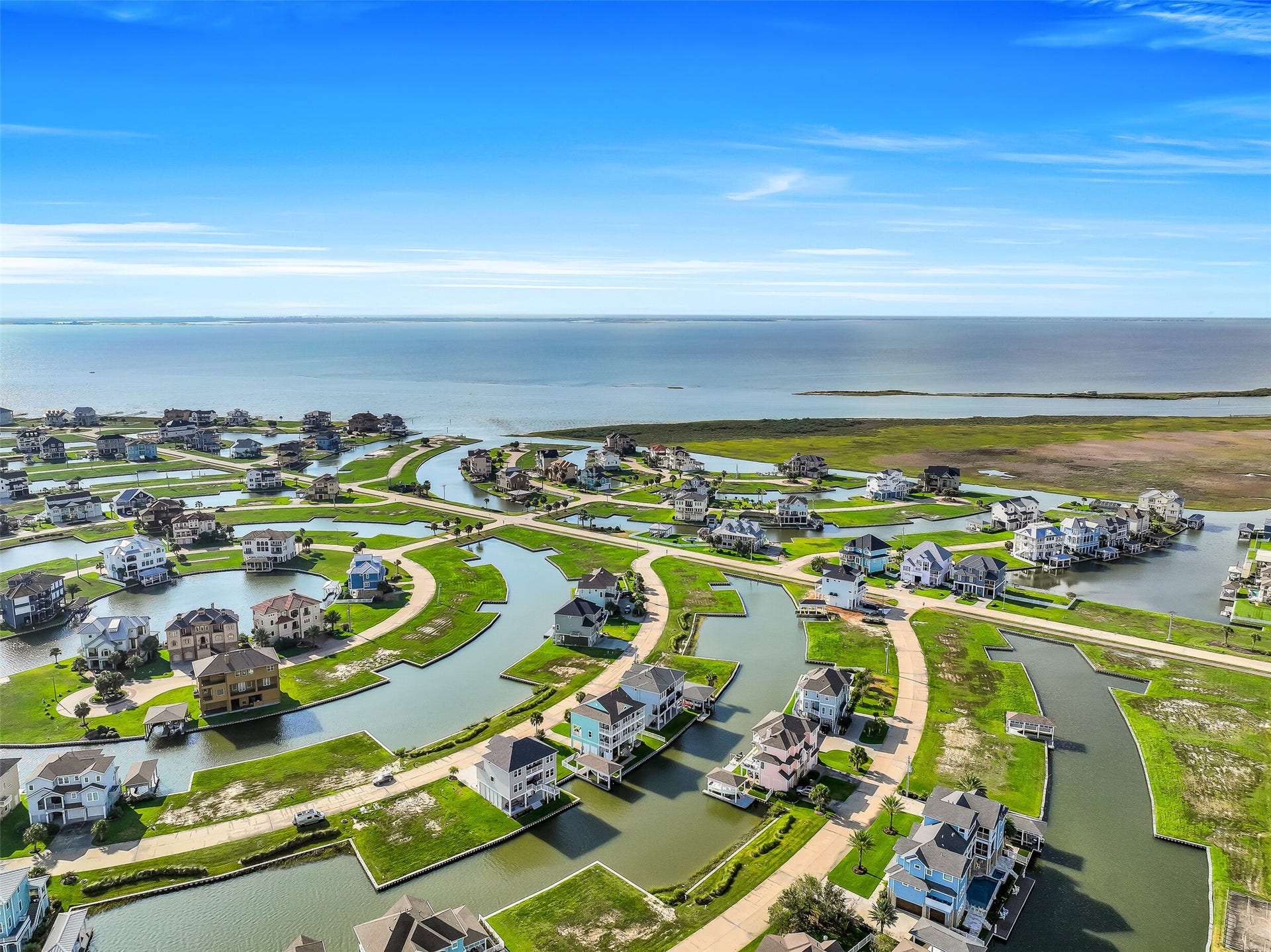 12 Fleming, Hitchcock, TX 77563 From above you can see exactly why Harborwalk is unlike anything else on the Gulf Coast. Manicured landscaped reserves, winding canals, a full-service marina, and a manned entry gate all surrounding one of the most completely rebuilt waterfront homes in the community. This is 12 Fleming from the air, and the view only gets better from the inside.