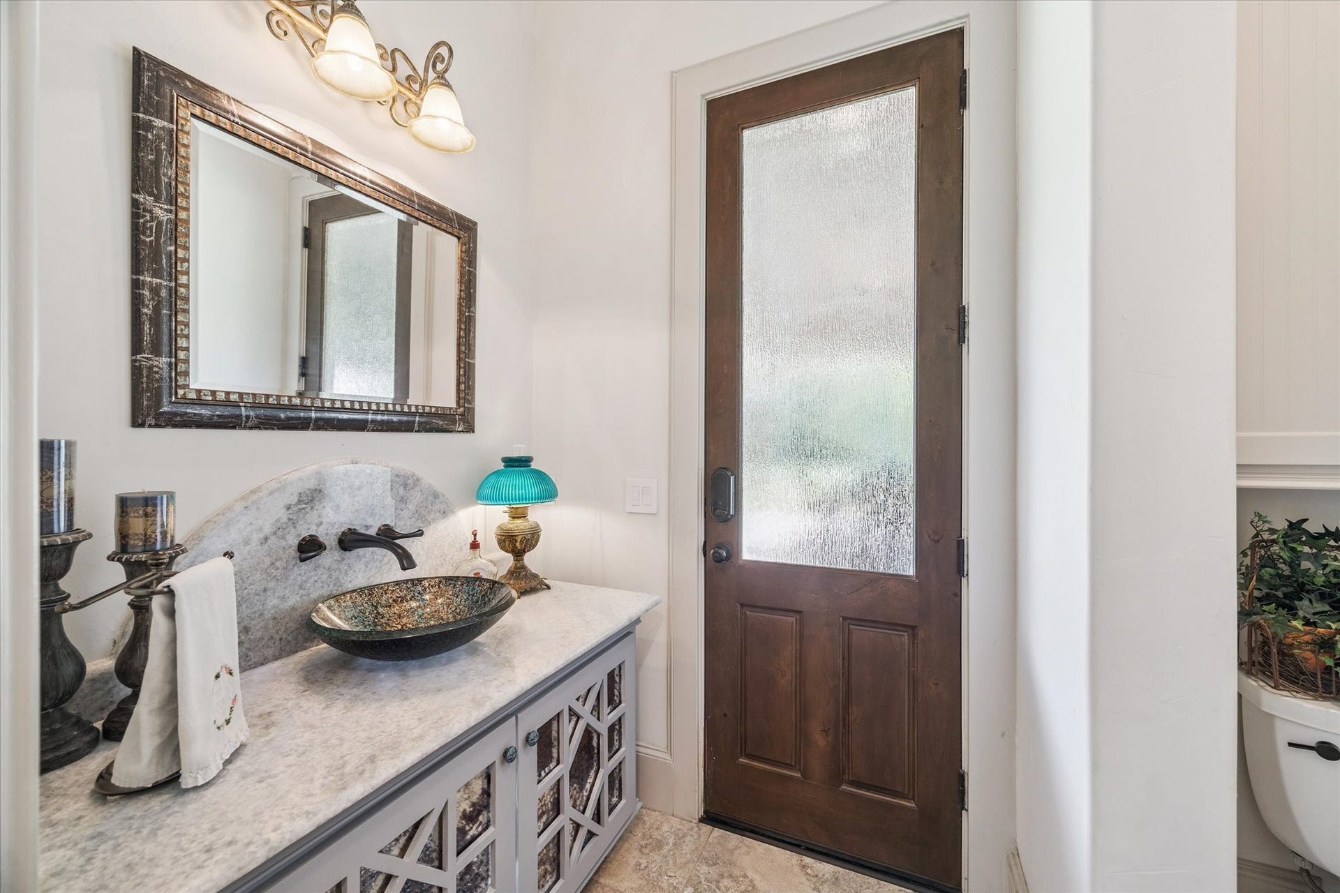 Powder bath for guests on first floor off kitchen, also leads out to the outdoor patio.