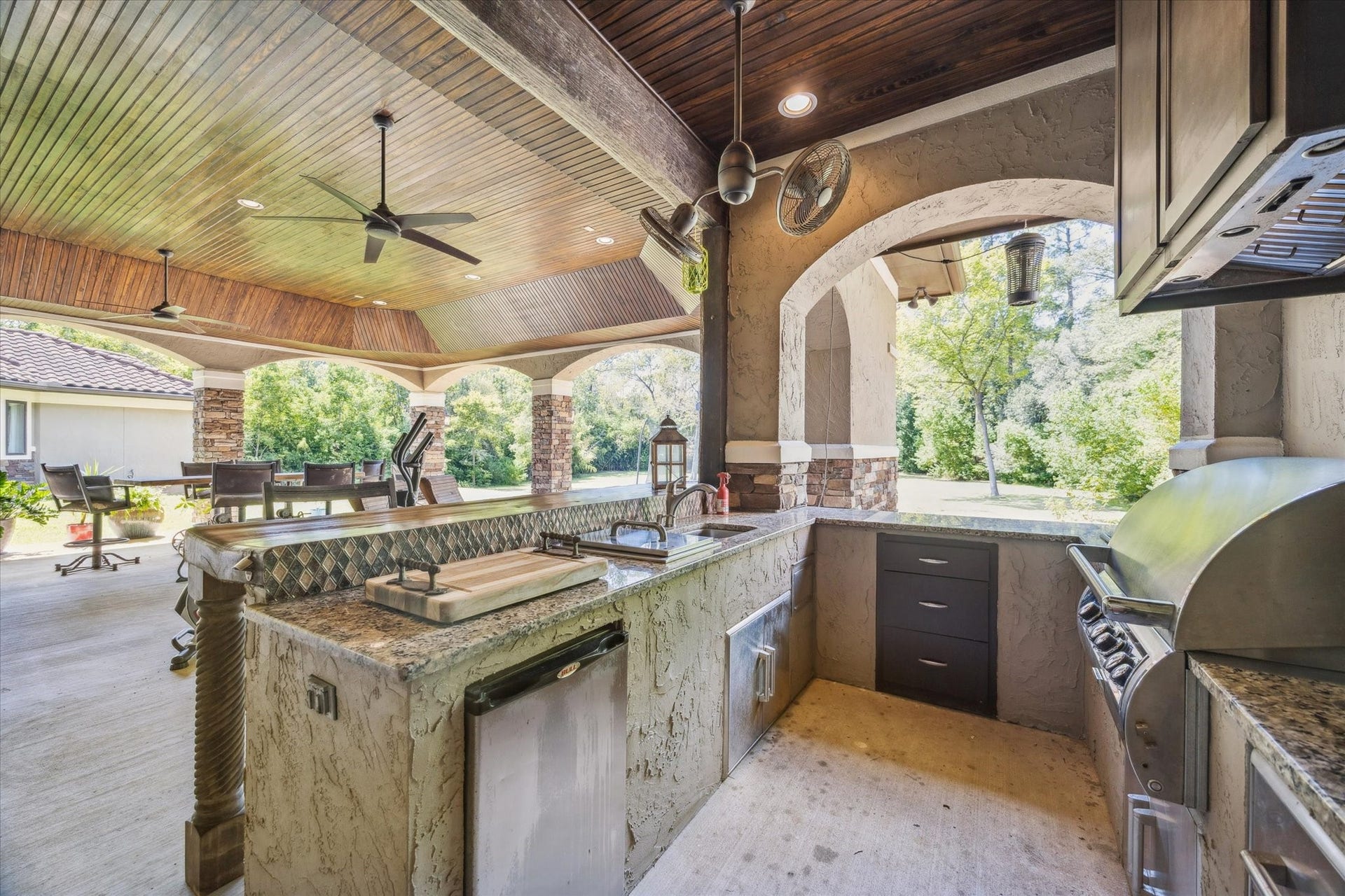 Outdoor kitchen equipped with beverage refrigerator, grill, and sink
