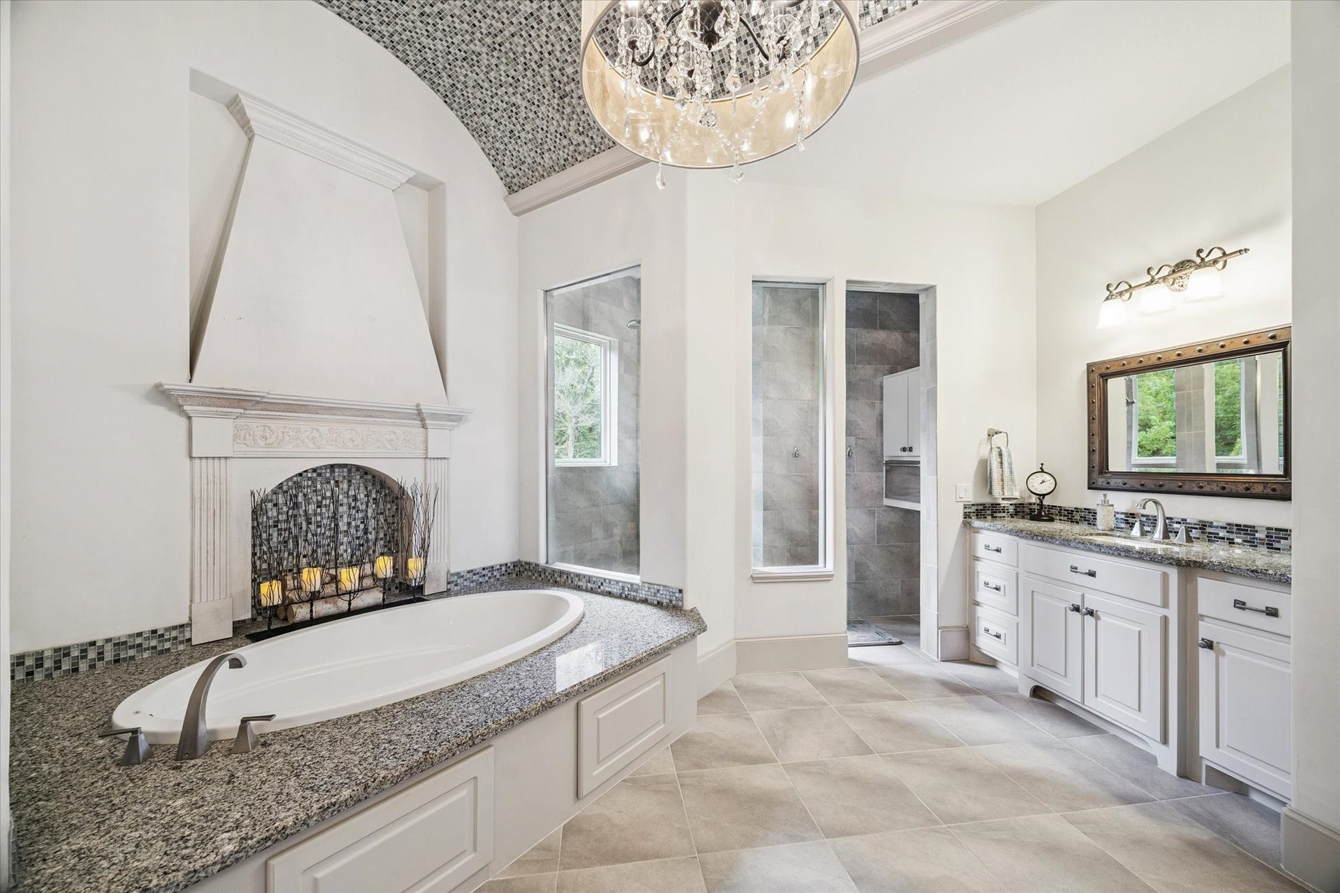 Spa-like primary bathroom with soaking tub, separate shower, and double vanities
