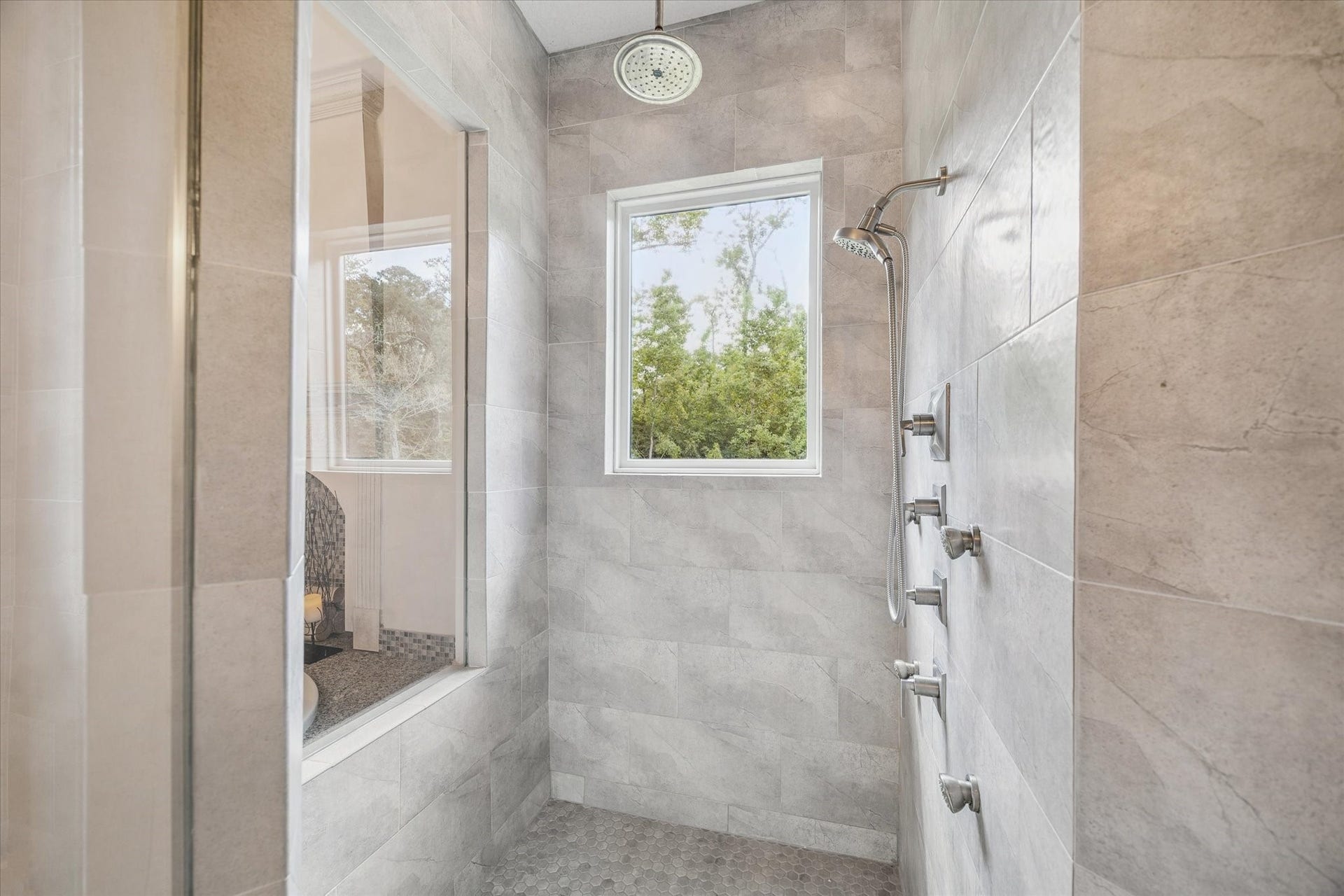 Spa-like primary bathroom with soaking tub, separate shower, and double vanities