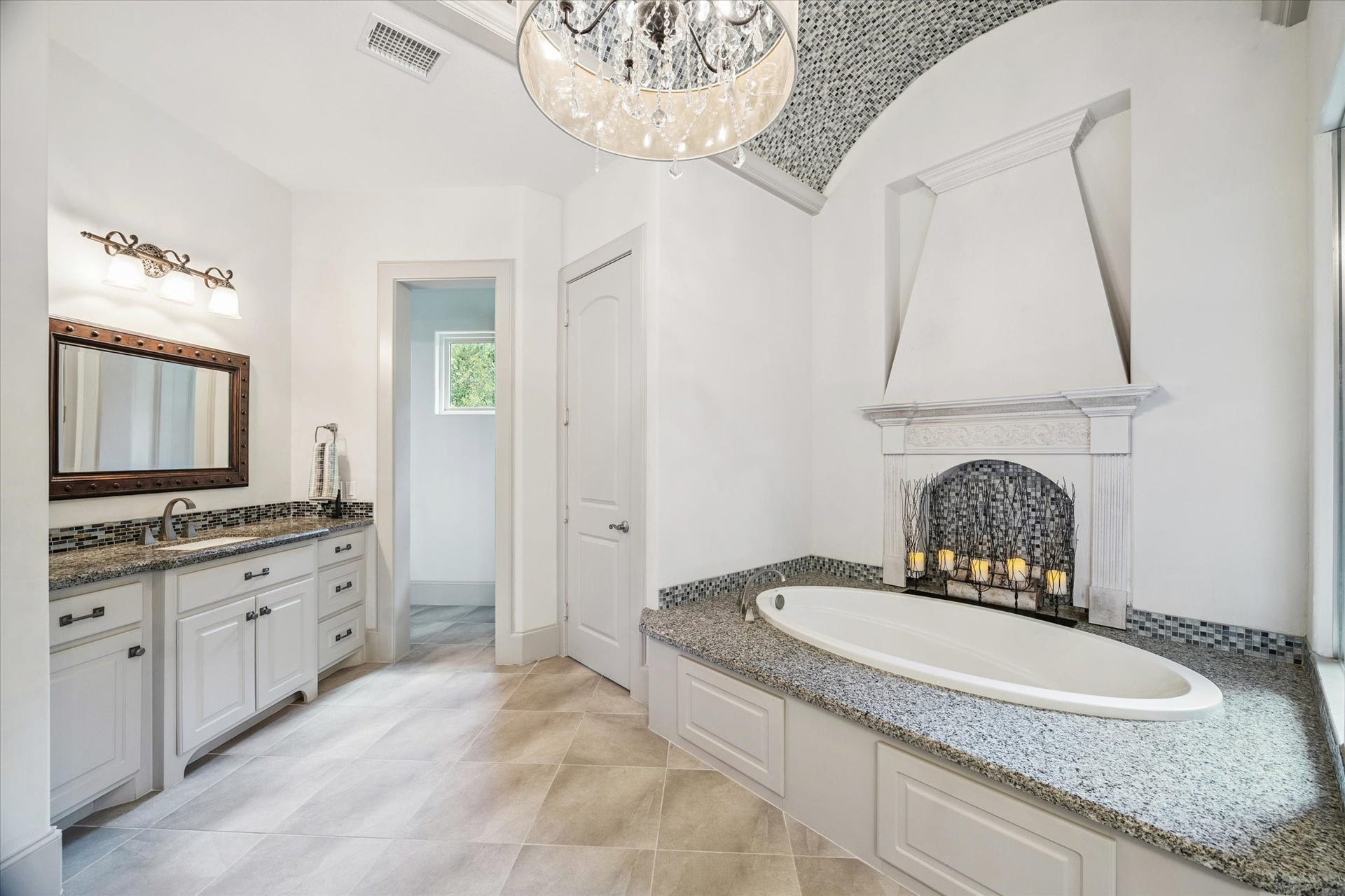 Spa-like primary bathroom with soaking tub, separate shower, and double vanities