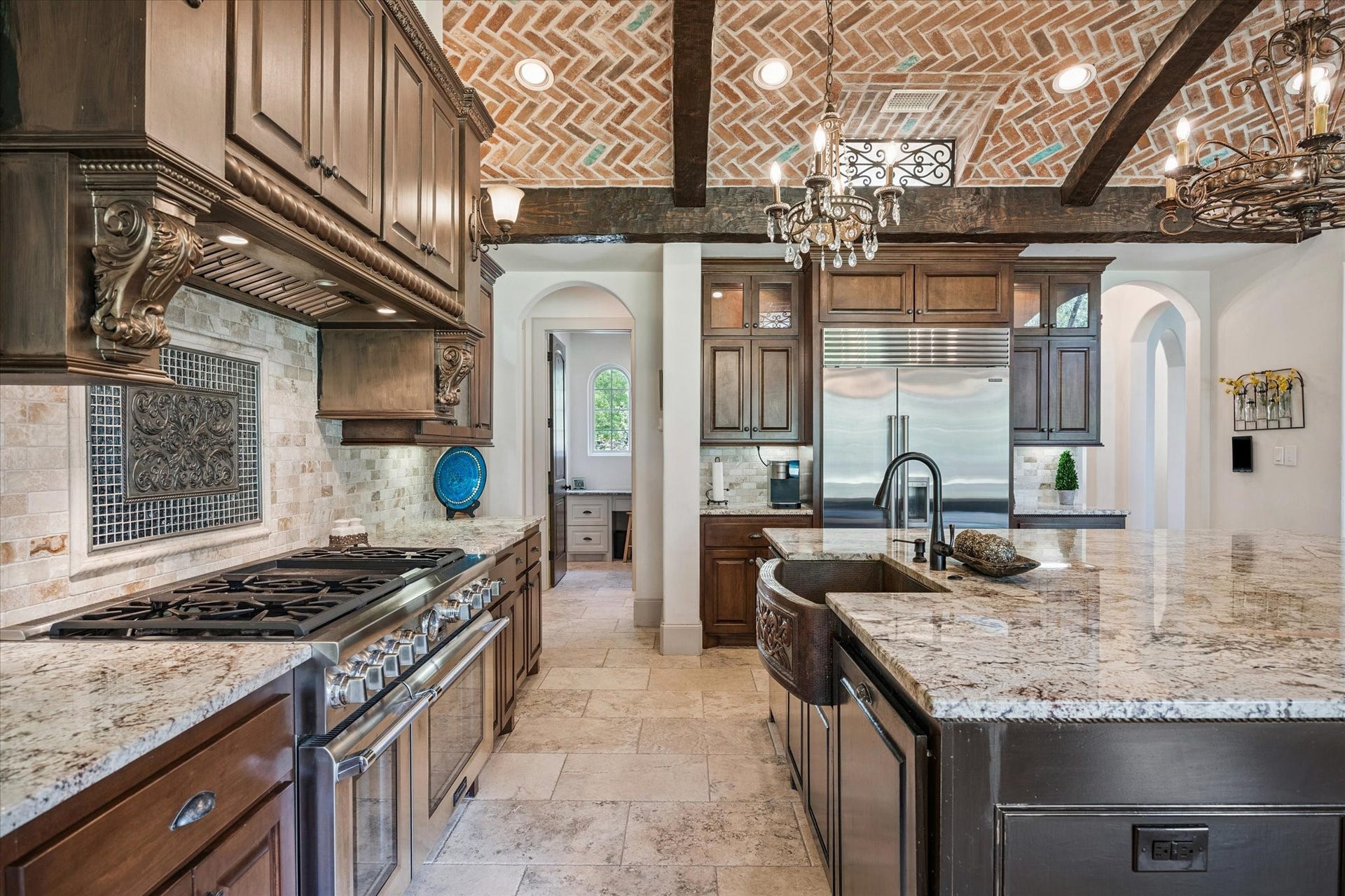 Gourmet kitchen perfect with large walk-in pantry for entertaining with spacious granite island and countertops, Thermador double ovens, and Sub-Zero refrigerator and freezer