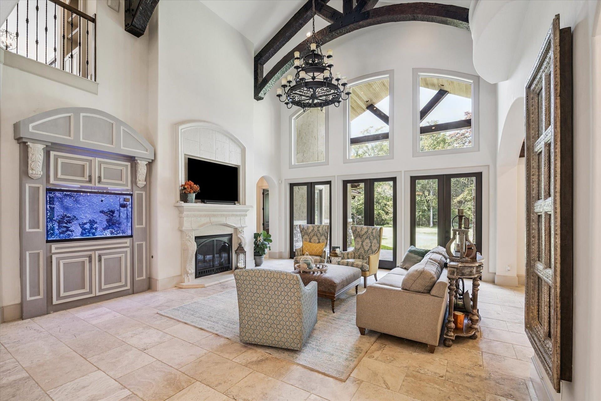 Gorgeous living room off of kitchen with gaslog fireplace, abundant natural light, and high ceilings