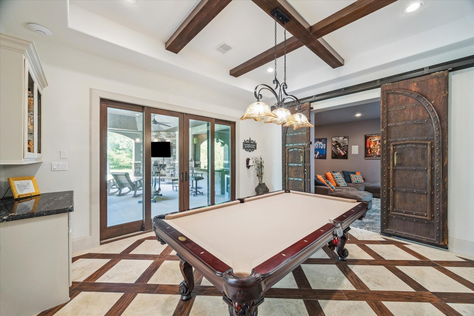 Game room on first floor perfect for entertaining right off of outdoor patio