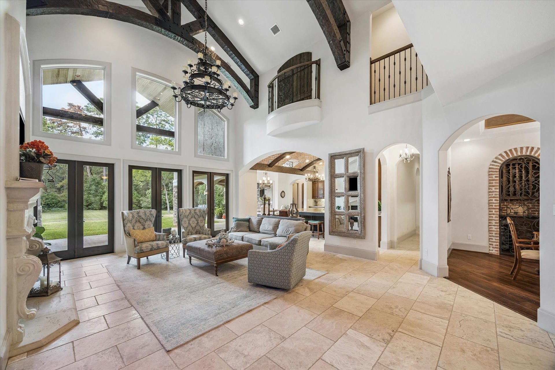 Gorgeous living room off of kitchen with abundant natural light and high ceilings